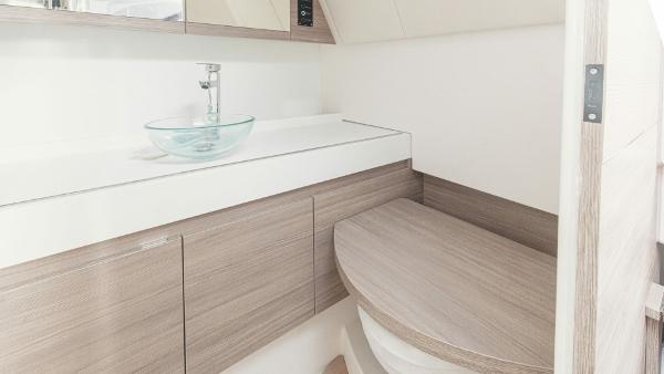 Modern bathroom interior of 2025 Saxdor 400 GTC boat with sleek wooden cabinetry.