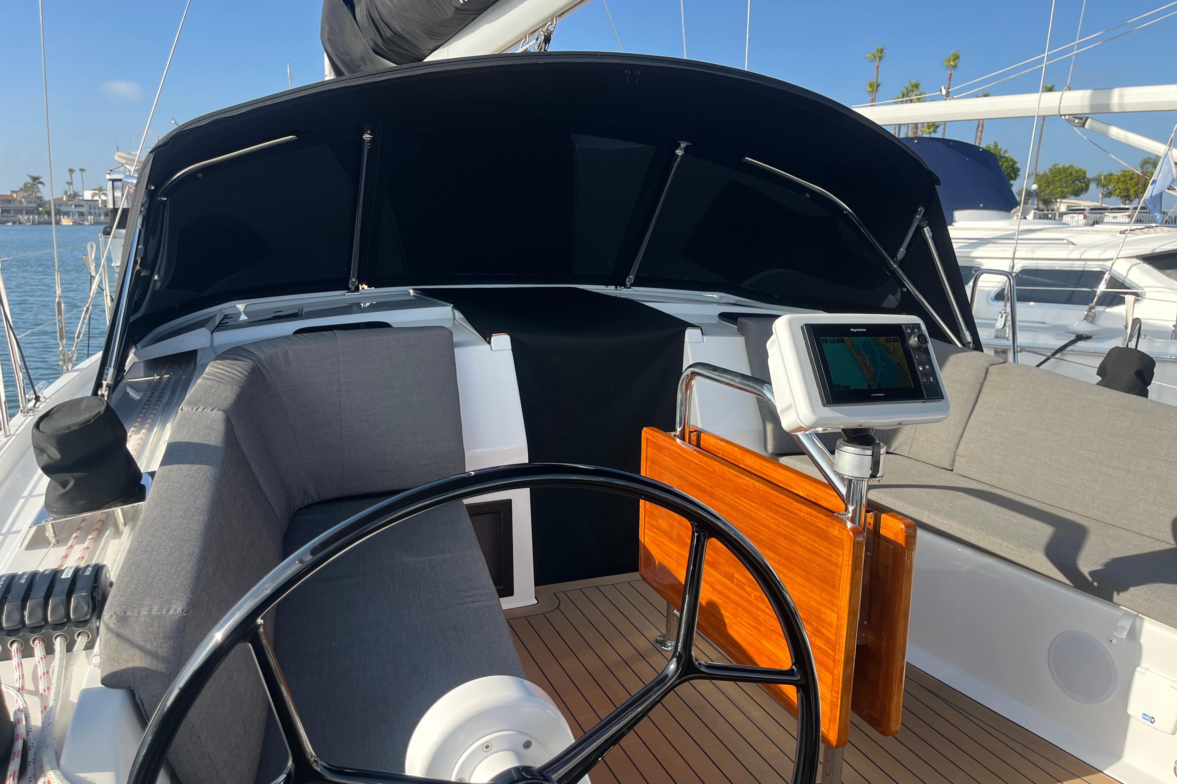 2025 Hanse 360 yacht cockpit with steering wheel and navigation system.