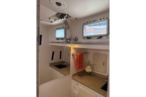 Interior of 2011 Reliance 44 yacht bathroom with dual sinks and porthole windows.