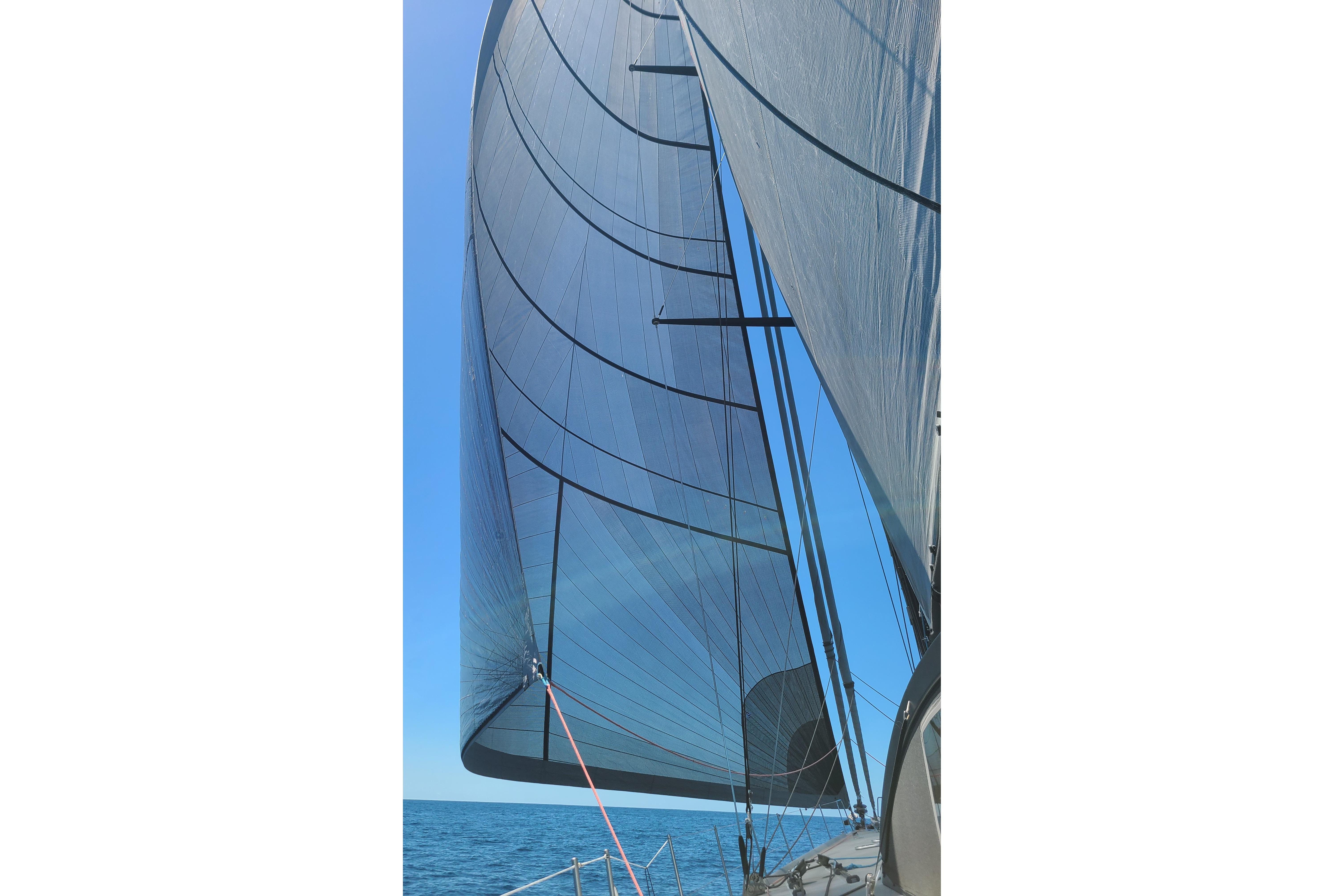 Sailing yacht Maxi One Design Grand Mistral 80, 1996, with sails unfurled on open sea.