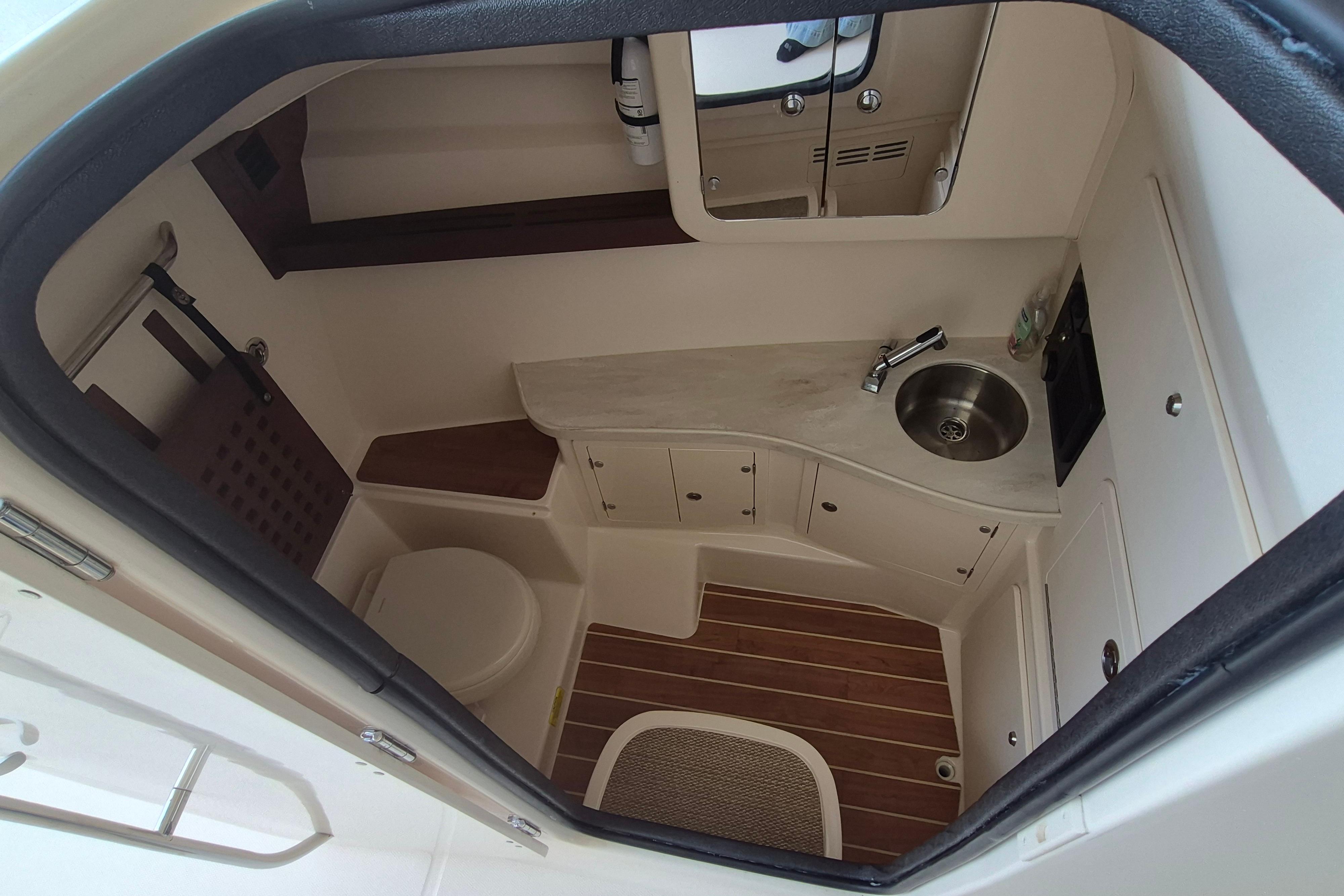 2019 Grady-White Freedom 335 boat interior with compact bathroom and sink.
