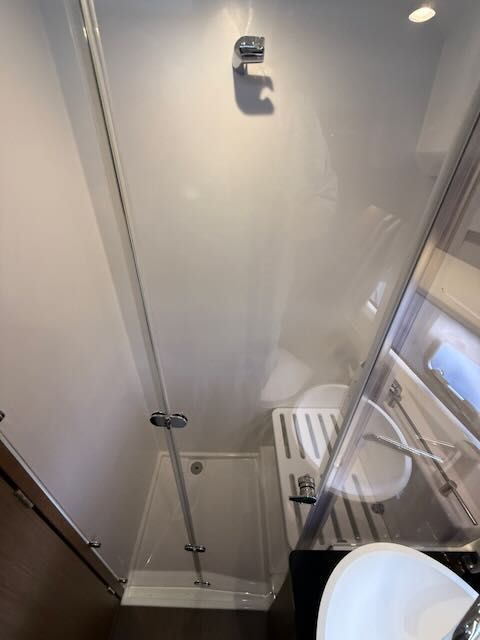 Shower and sink in a boat cabin.