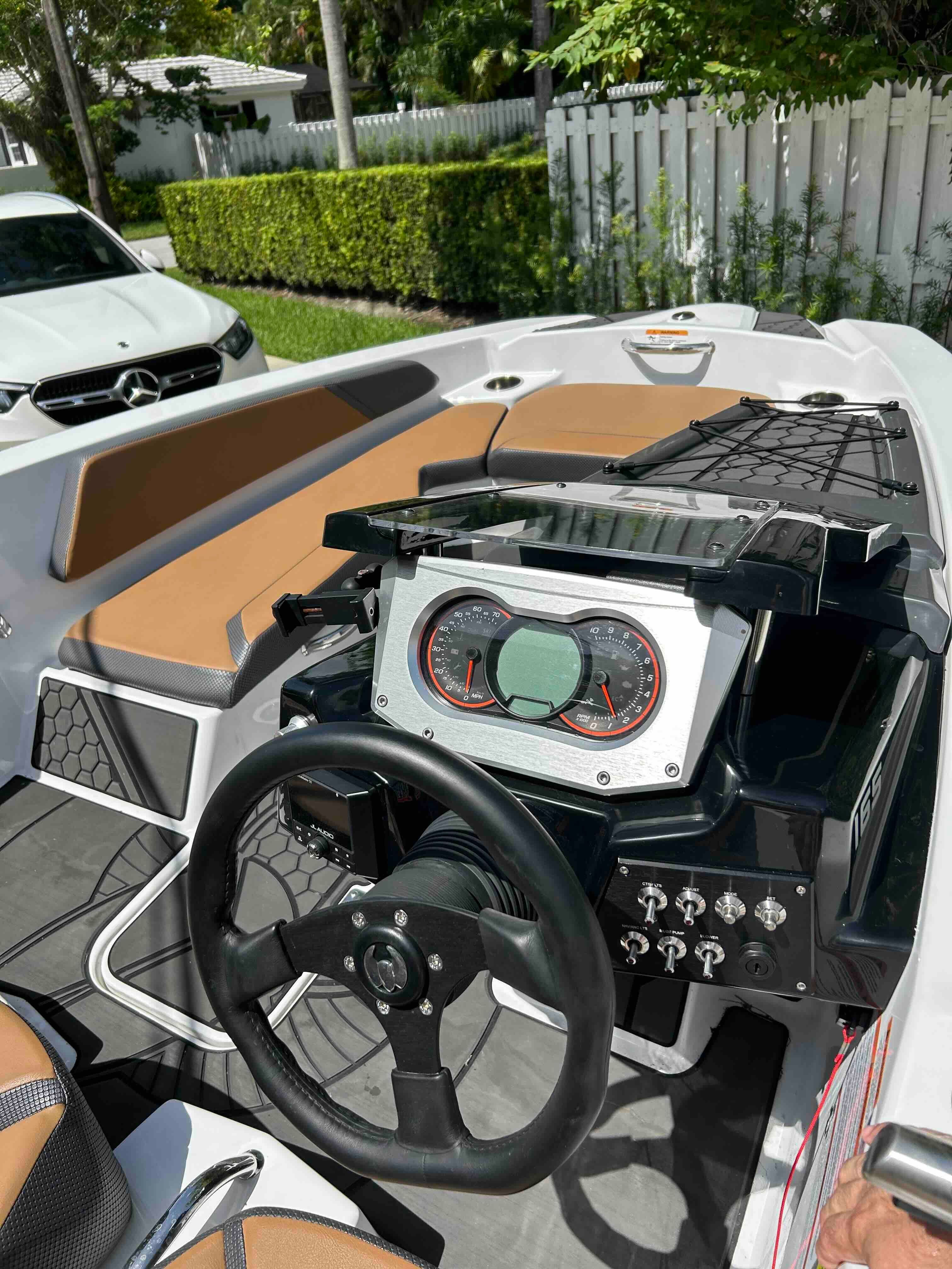 The image shows the cockpit of a 2022 Scarab 165 ID boat with a modern dashboard.