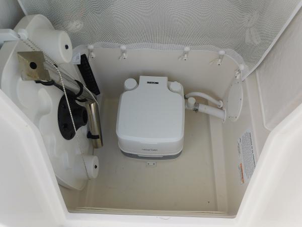 Portable toilet in 2025 Sailfish 232 CC boat compartment.