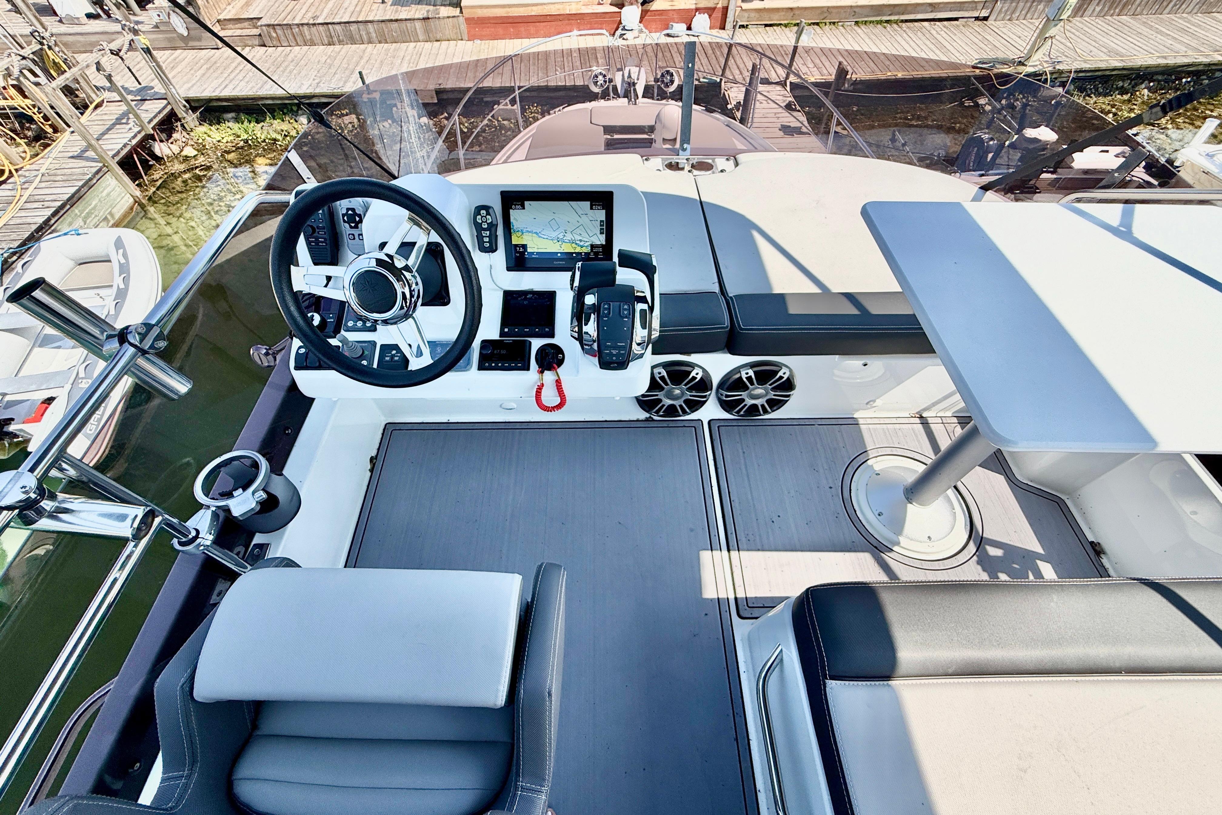 Flybridge of 2022 Jeanneau NC 1095 Fly, featuring helm station and seating area.