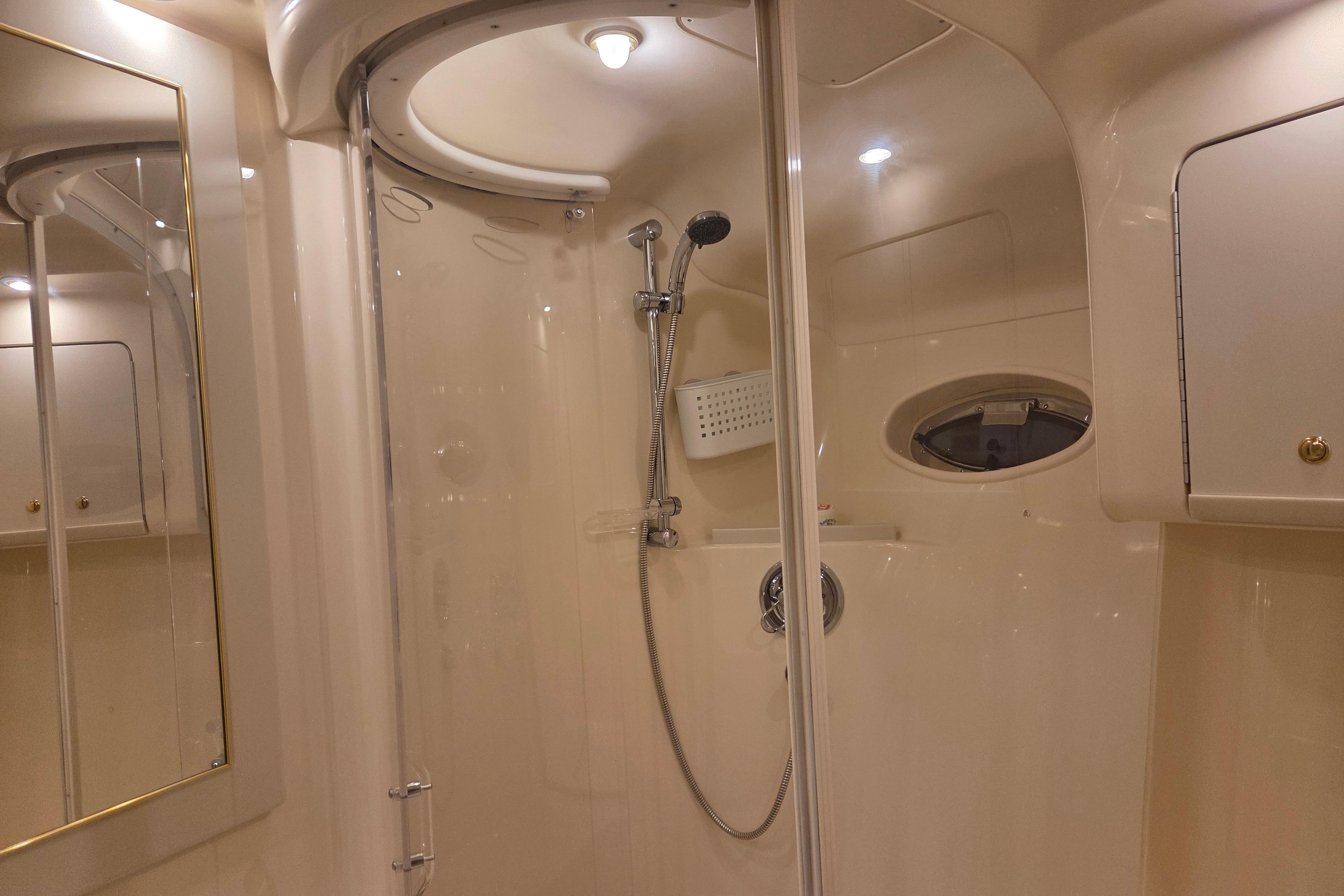 Luxurious bathroom interior of 2000 Sea Ray Sundancer 540 yacht with shower and mirror.