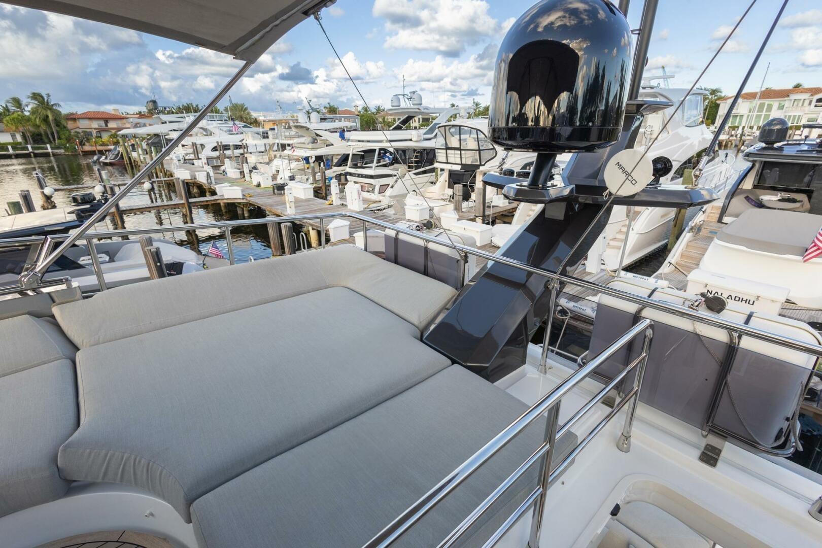 2023 Azimut S6 Sport-Fly yacht with spacious deck and luxurious seating at marina.