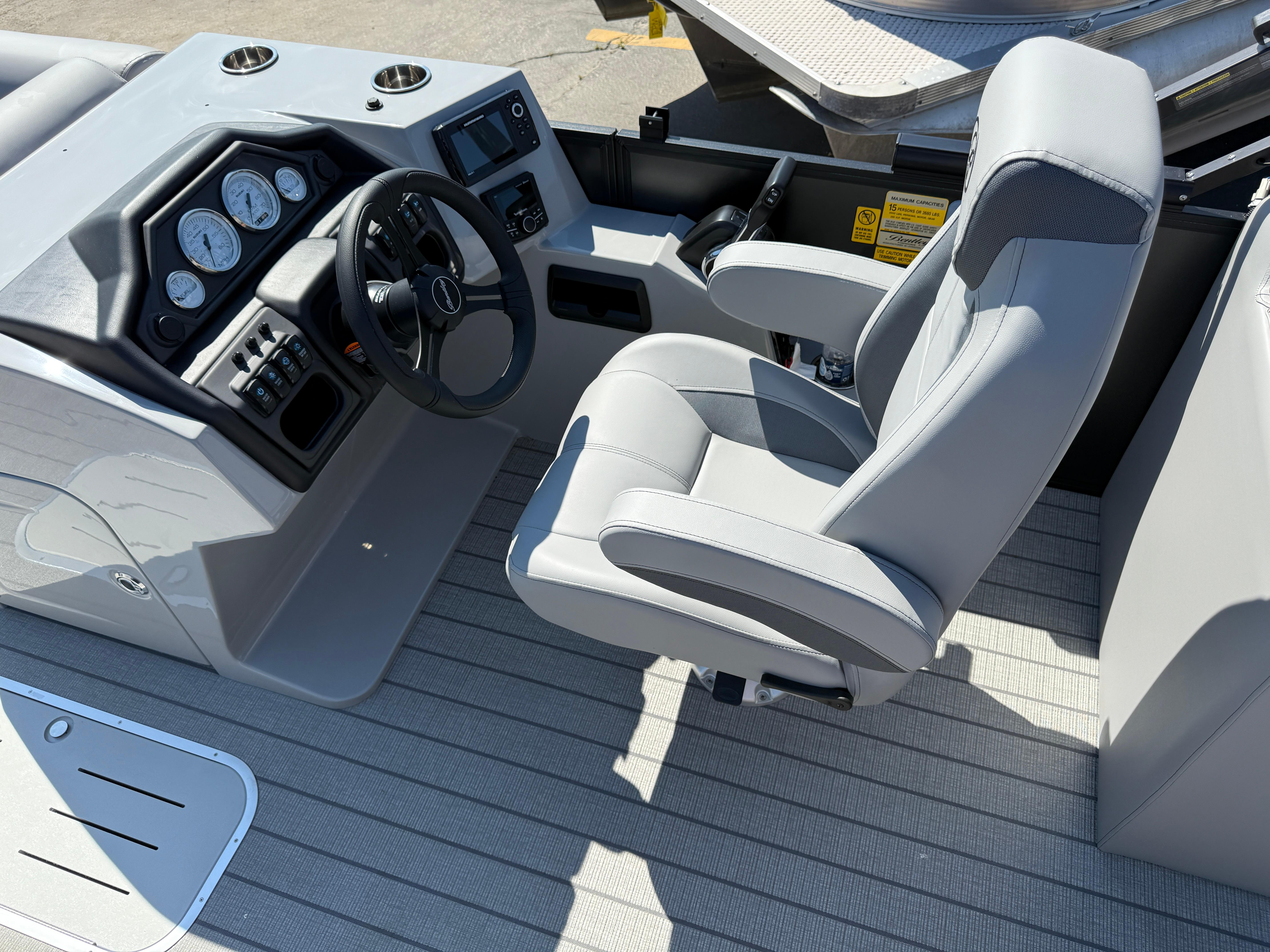 2026 Bentley Pontoons Legacy 223 Navigator helm with modern controls and comfortable captain's chair.