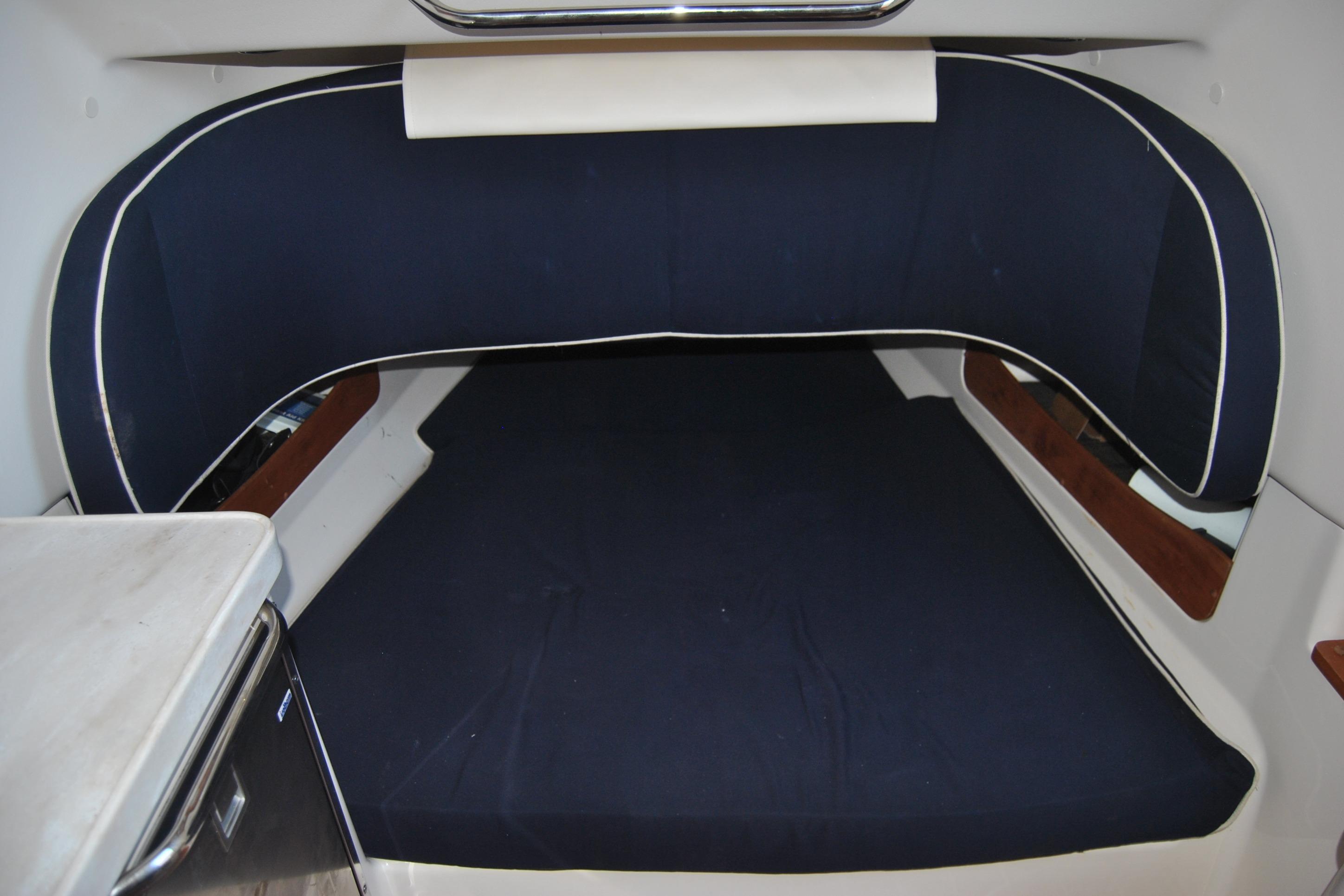 2018 Grady-White Canyon 376 cabin interior with blue cushioned seating.