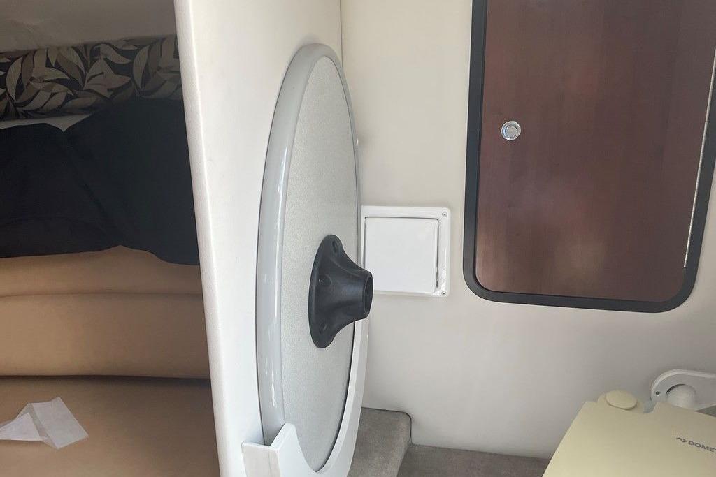 Interior cabin of 2015 Crownline 236 SC boat, featuring a door and seating area.