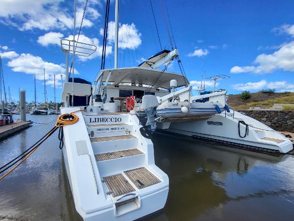 Catana 65 catamaran, 2009 model, docked at marina under clear blue sky.
