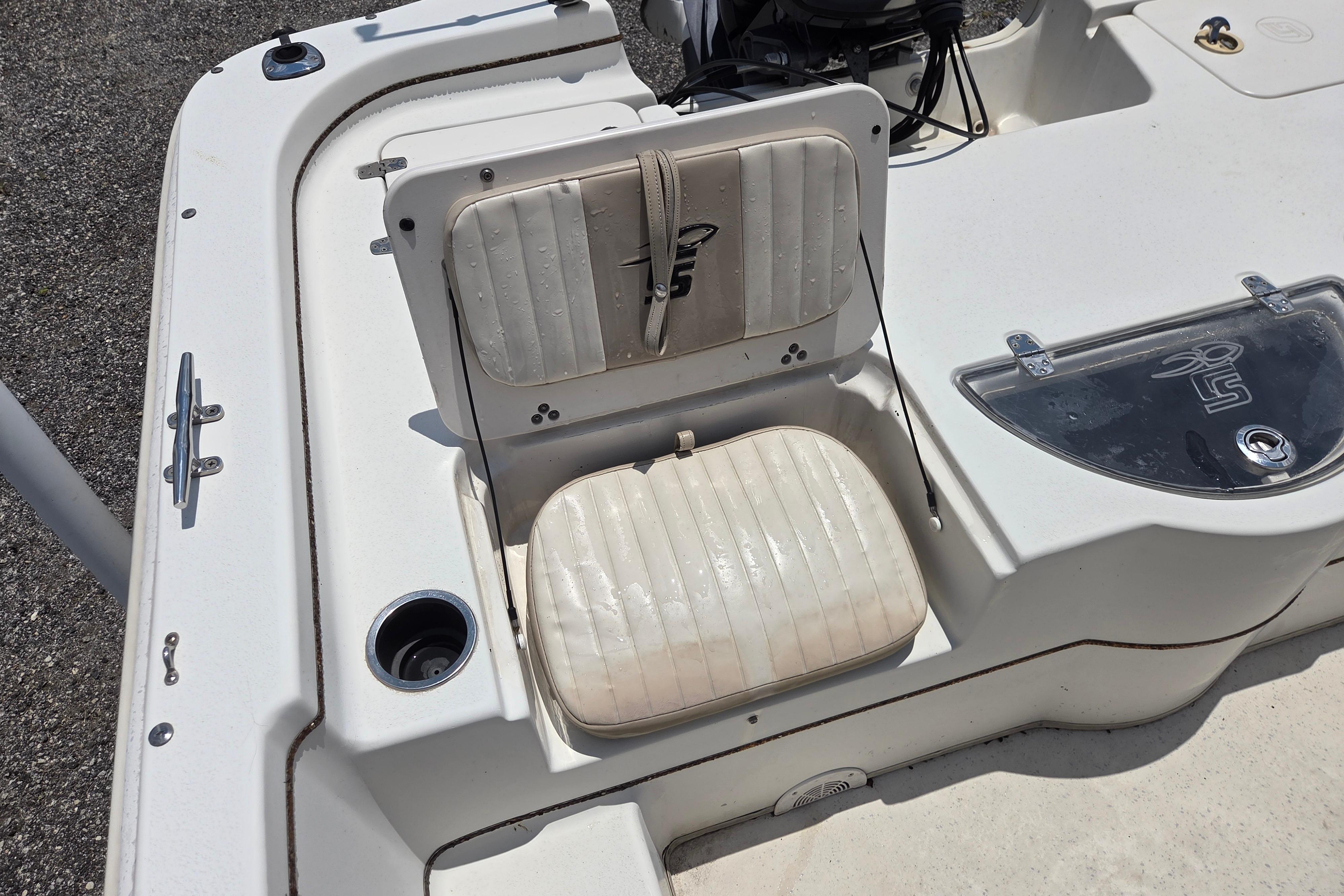 2016 Carolina Skiff 198 DLV boat interior with white seating and storage compartments.