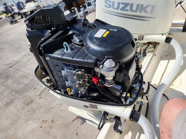2005 Pursuit 3070 Offshore Center Console with Suzuki outboard engine, open for maintenance.