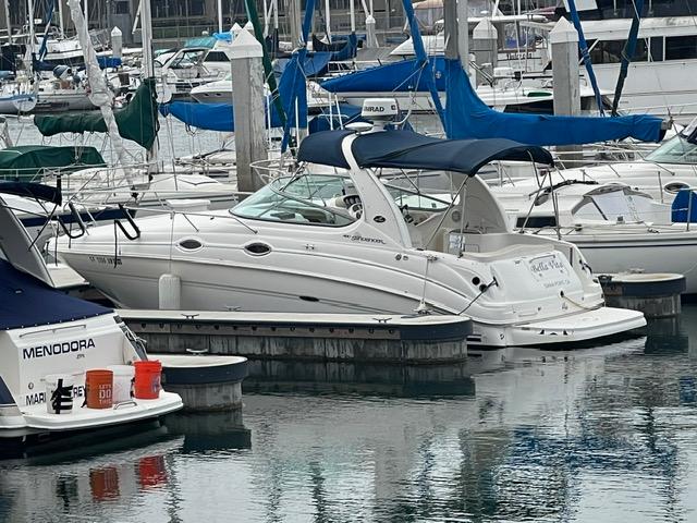 2004 Sea Ray 280 Sundancer docked at a marina with other boats.