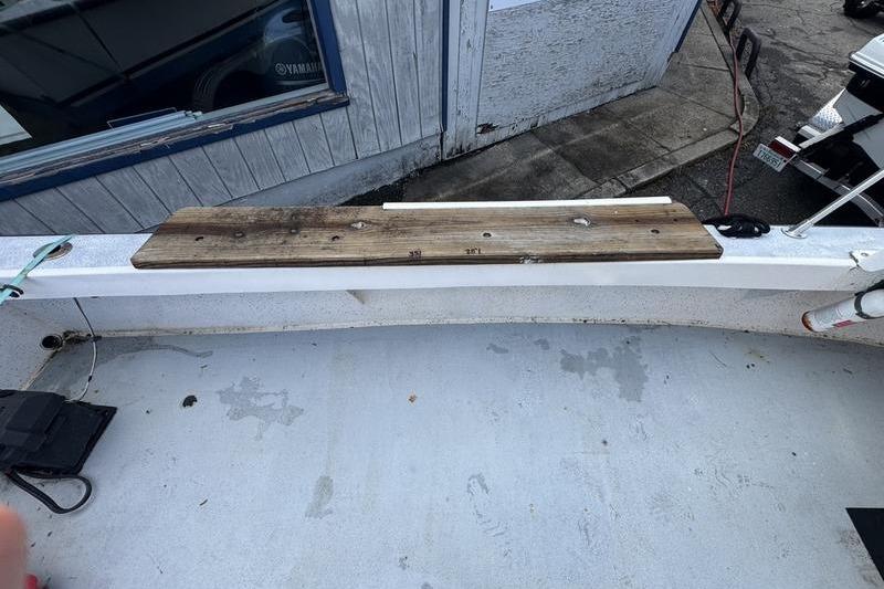 2001 ROS Boats 19 RUNABOUT deck with wooden plank and weathered surface.