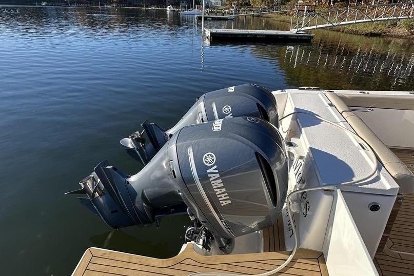 2016 Pursuit DC 325 Dual Console with twin Yamaha outboard engines on a calm lake.