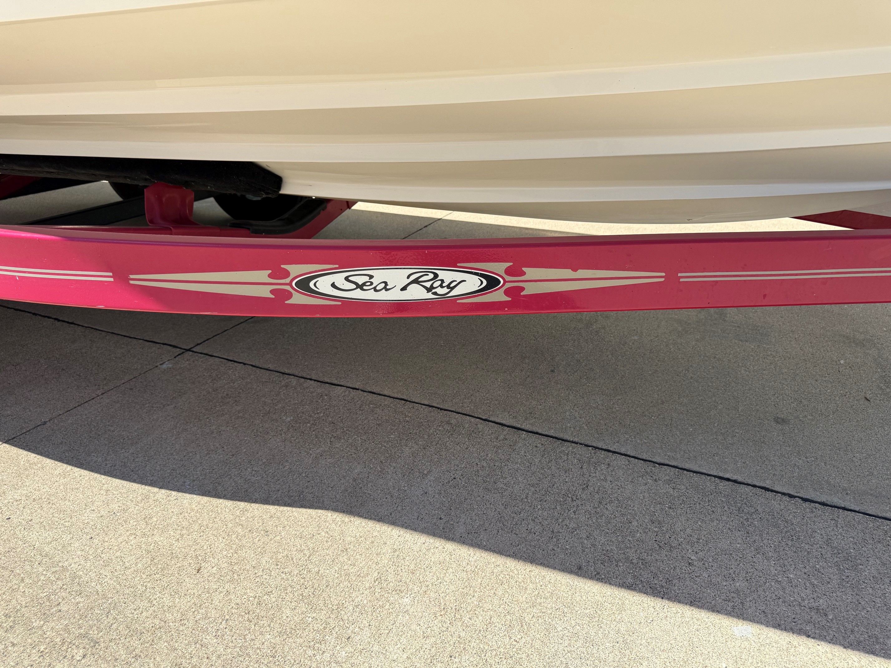 Sea Ray 230 Select boat trailer, 2007 model, on concrete surface.