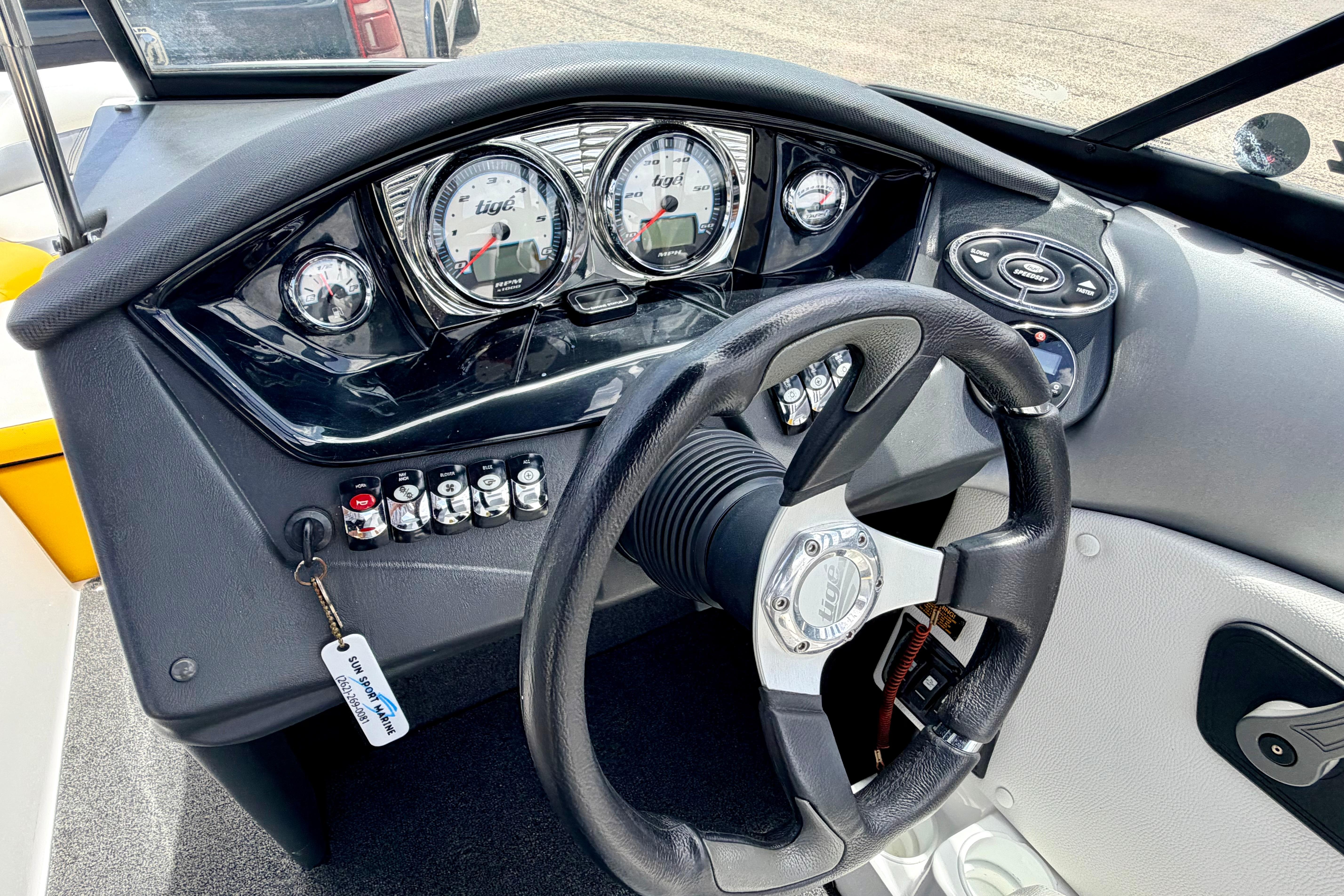 2014 Tigé R20 boat dashboard with steering wheel and control panel.
