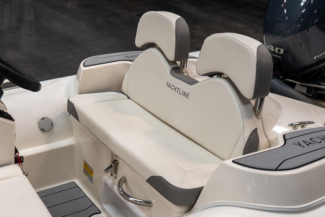 2026 Zodiac Yachtline 360 boat interior with white cushioned seating and sleek design.