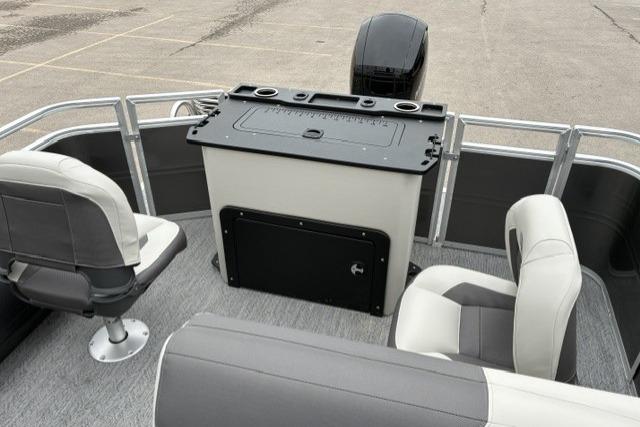 2026 Sun Tracker Fishin' Barge 22 DLX interior with seating and console, ideal for fishing trips.