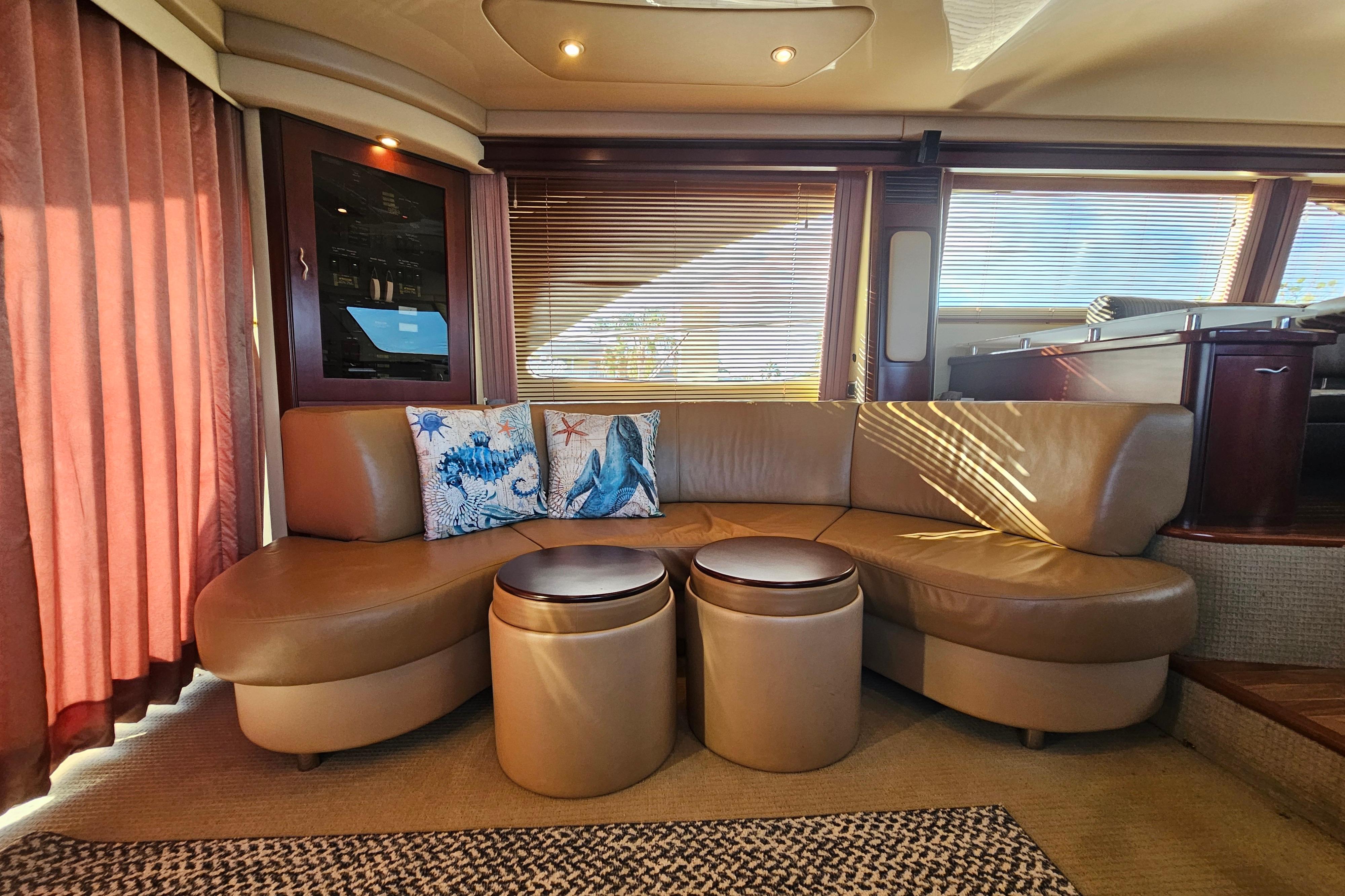 Luxurious interior of 2006 Sea Ray 580 Sedan Bridge with leather seating and nautical decor.