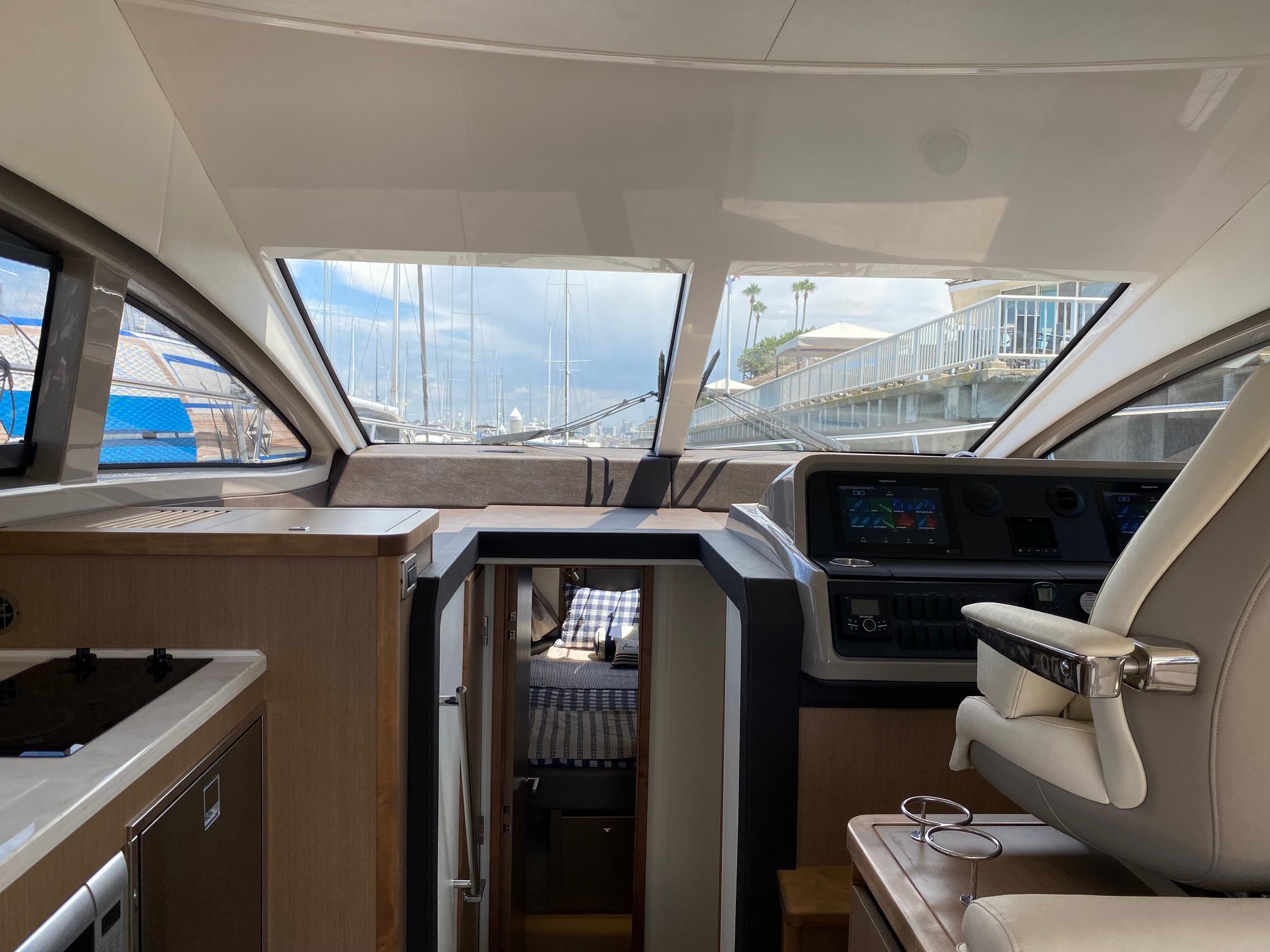 Interior view of 2018 Sea Ray 400 Fly yacht, featuring helm and cabin area.