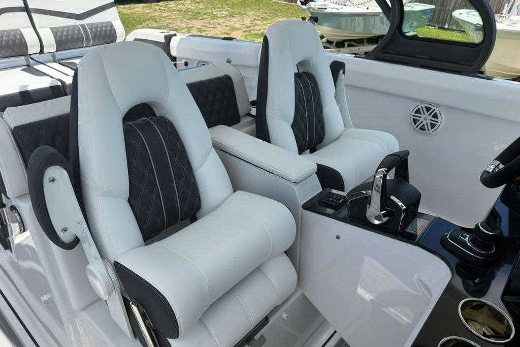 Luxurious interior of 2026 Monterey Elite 30 OB boat with plush seating and modern controls.