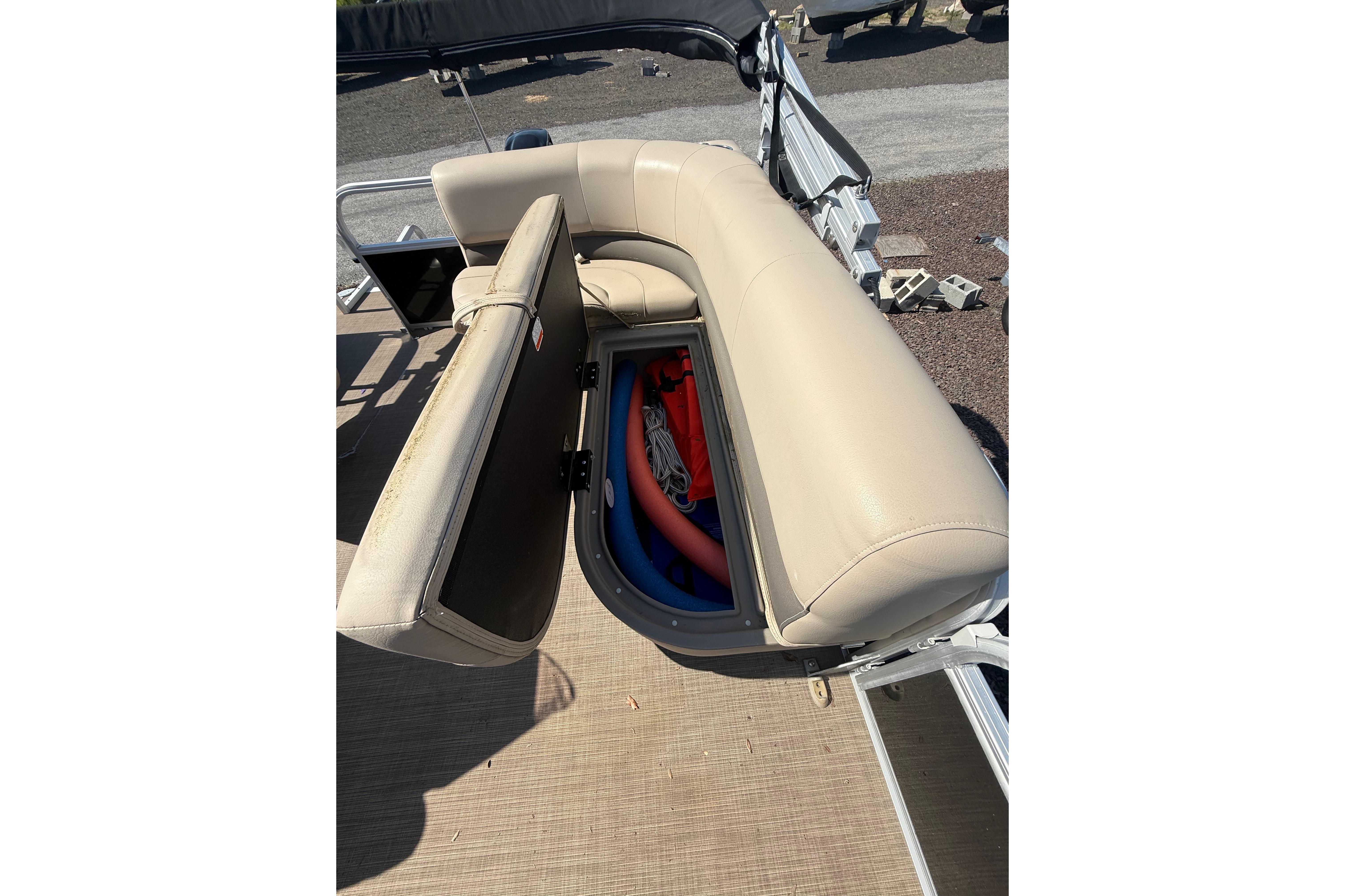 2021 Sun Tracker Bass Buggy 16 XL Select with open storage compartment under beige seating.