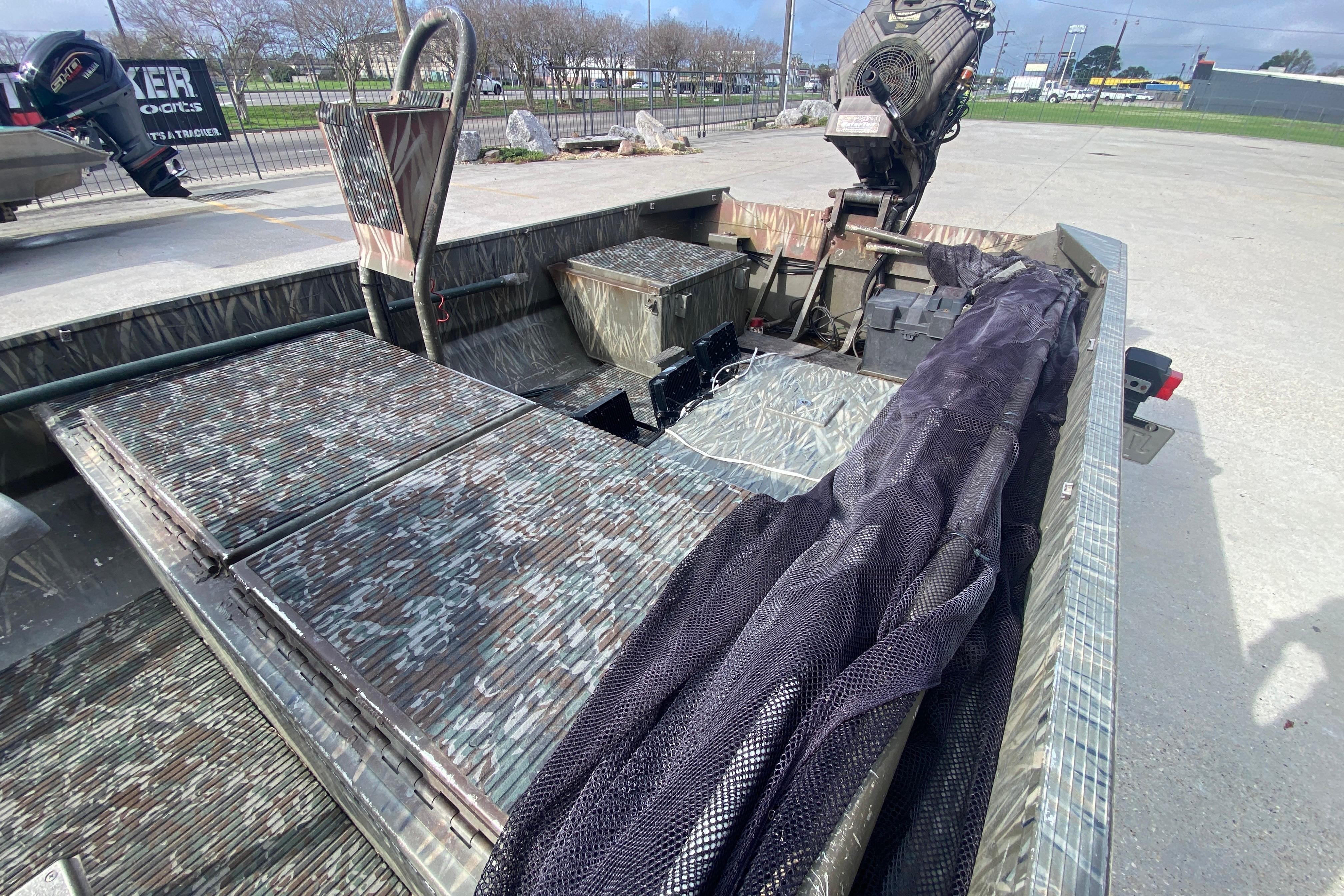 2009 Gator Trax MUD BUDDY 17 X 50 boat with camouflage interior and motor.