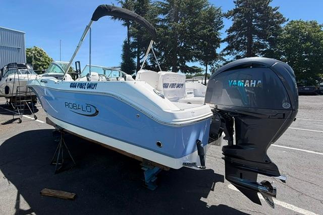 2024 Robalo R207 Dual Console boat with Yamaha outboard motor in a sunny marina.