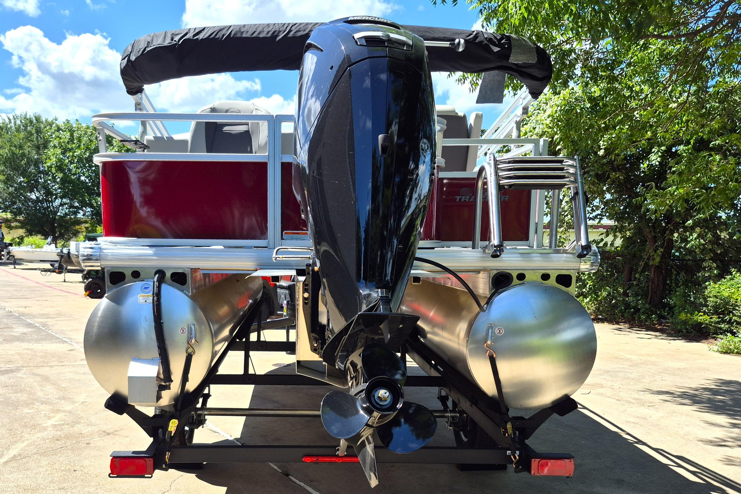 2026 Sun Tracker Bass Buggy 18 DLX pontoon boat, rear view with motor and ladder.