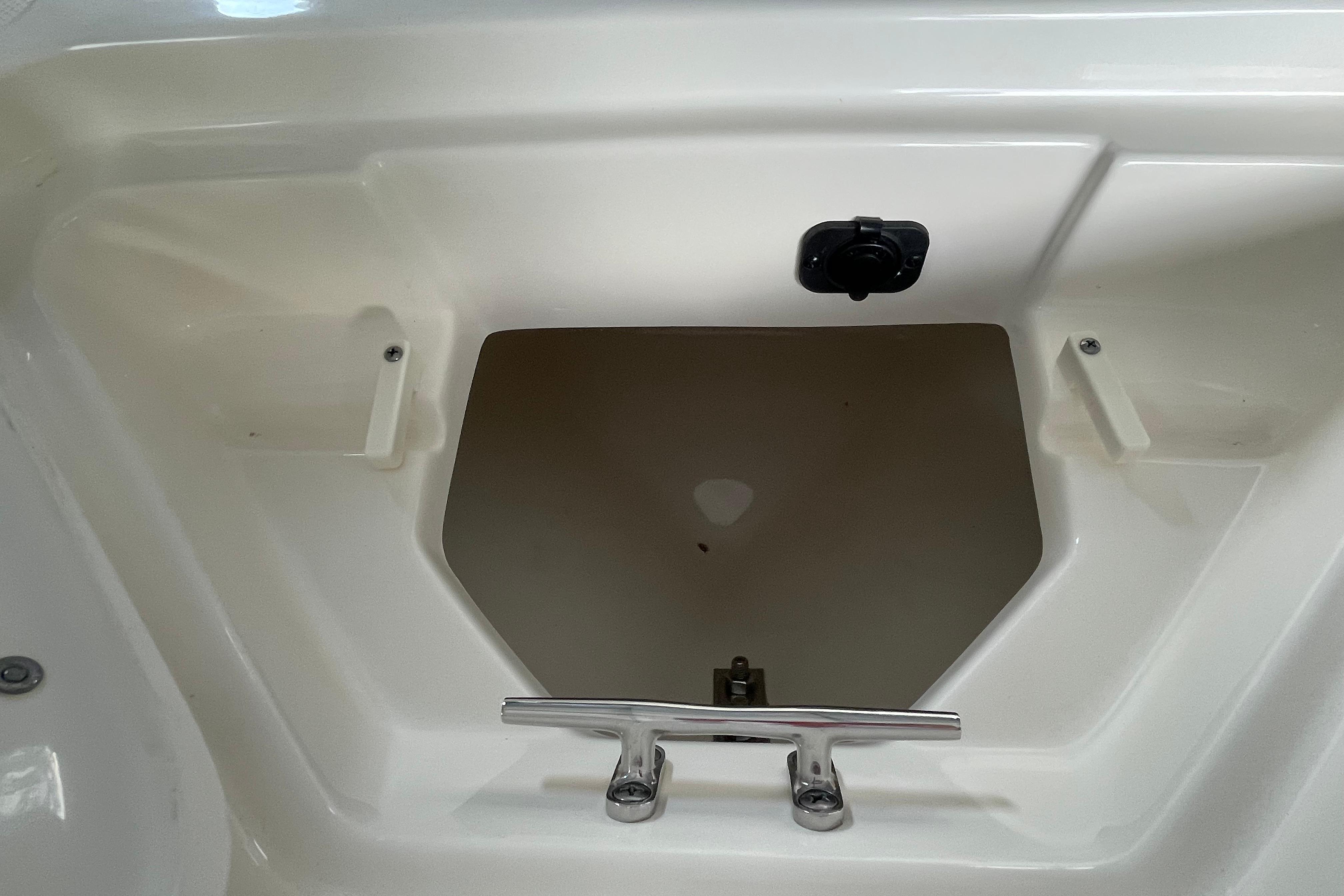 Storage compartment of 2024 Pioneer 180 Islander boat, featuring a sleek white interior.
