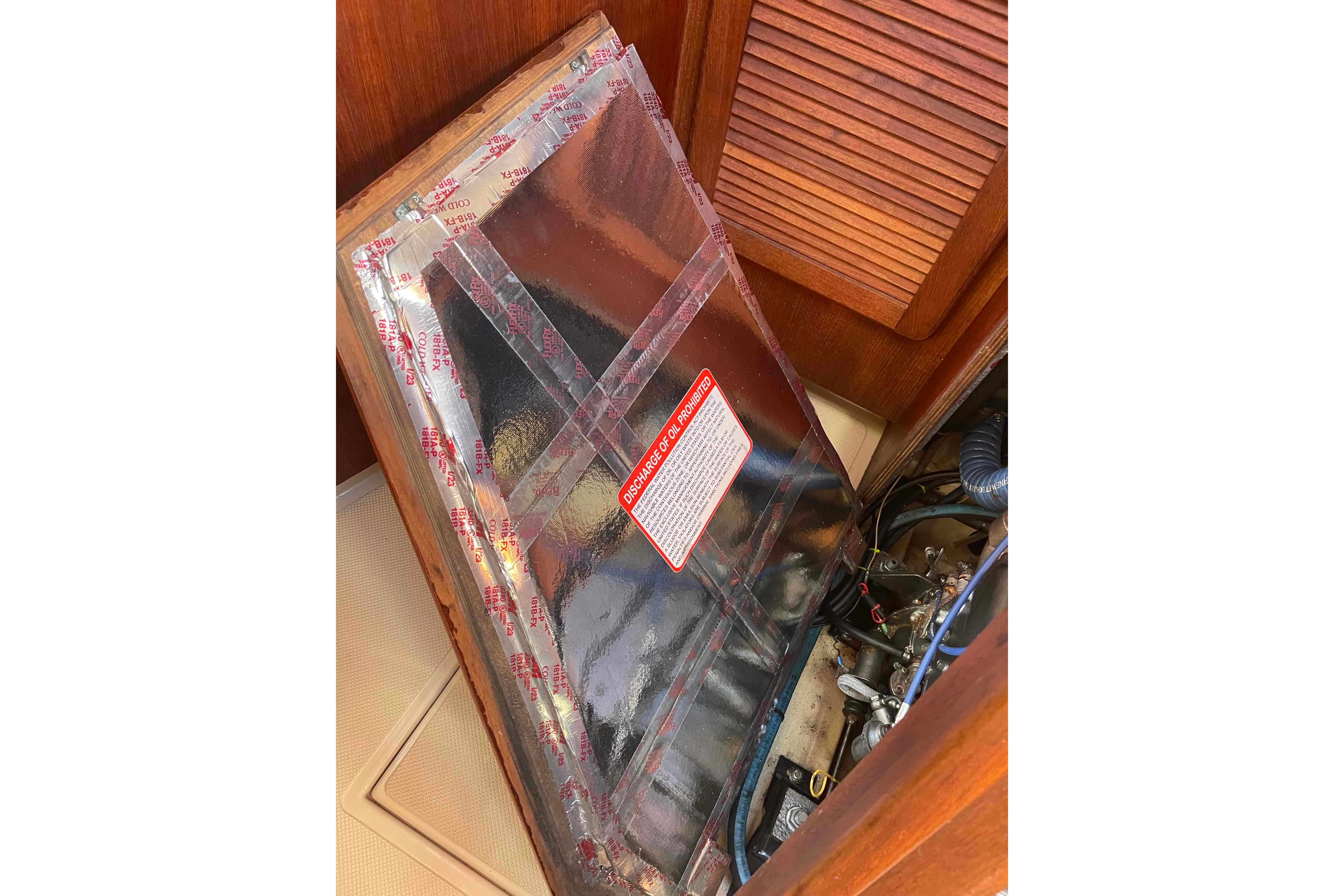 1989 Island Packet 35 engine compartment with protective cover and visible components.
