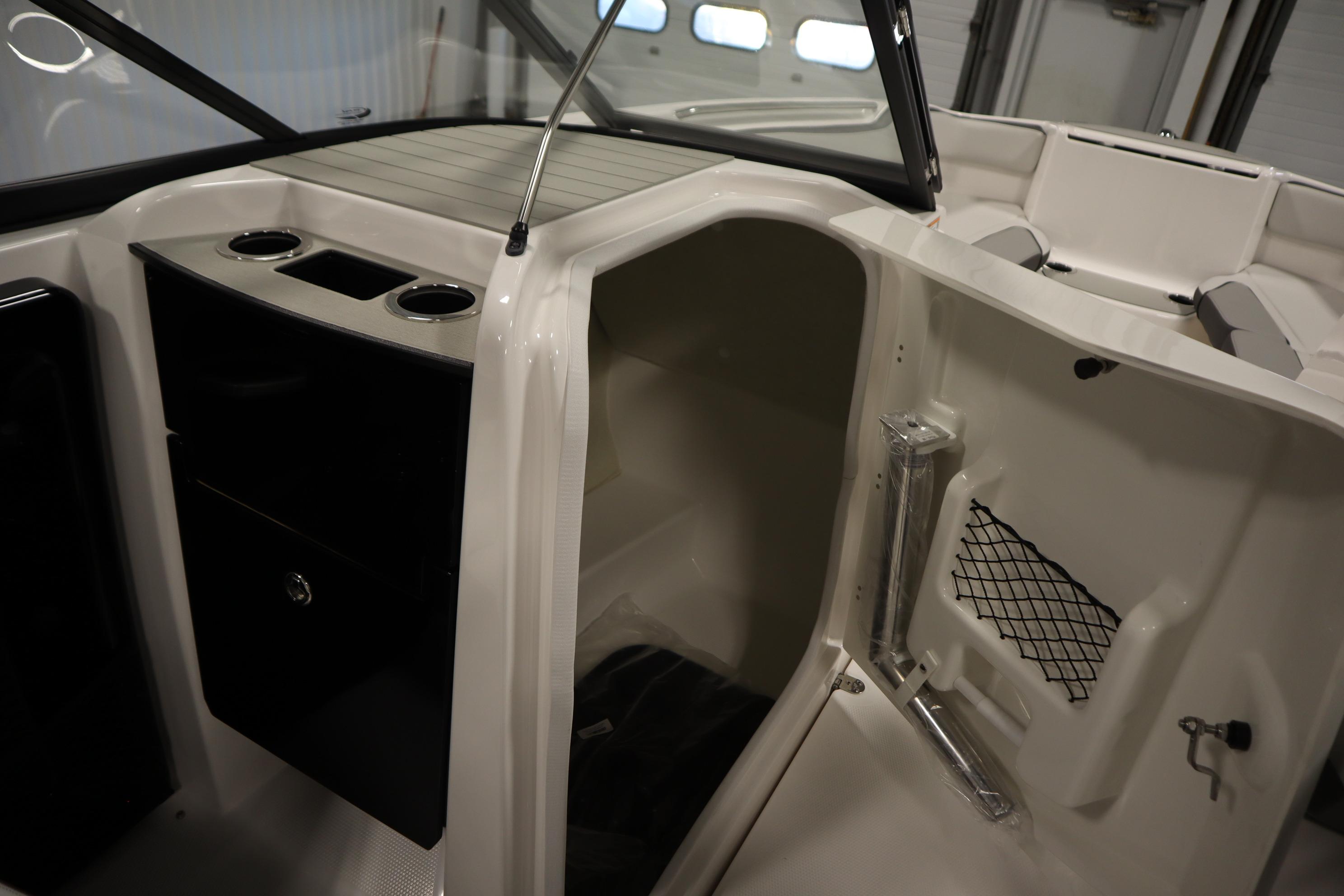 2026 Yamaha Boats AR250 interior with storage compartment and cup holders.