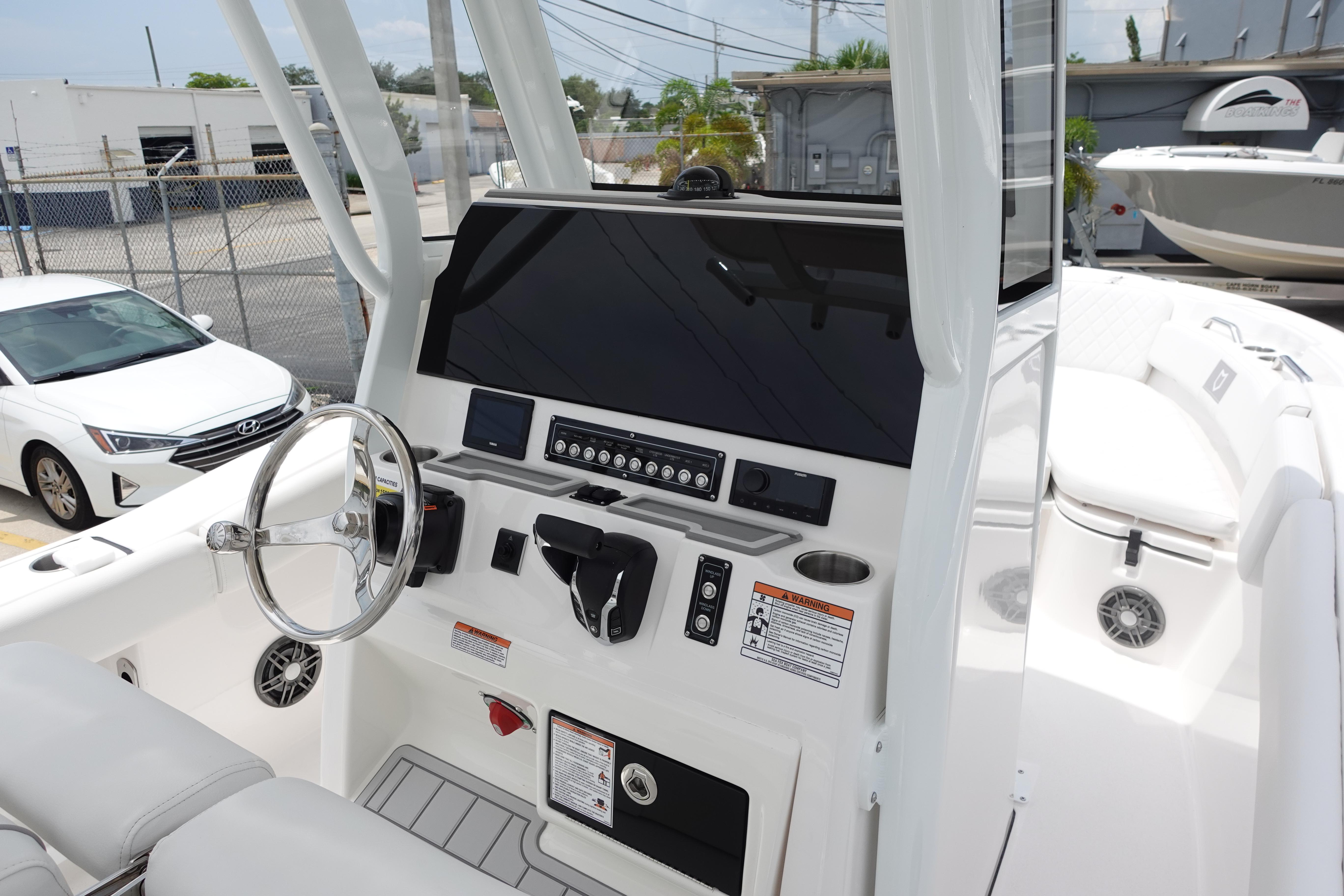 2025 Sea Fox 248 Commander boat dashboard with steering wheel and control panel.