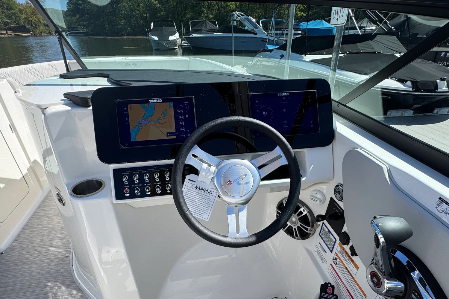 Sea Ray SDX 270 helm, 2026 model, featuring Simrad navigation.