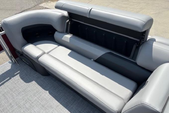 2026 Sun Tracker SportFish 20 DLX boat interior with gray cushioned seating and storage compartment.