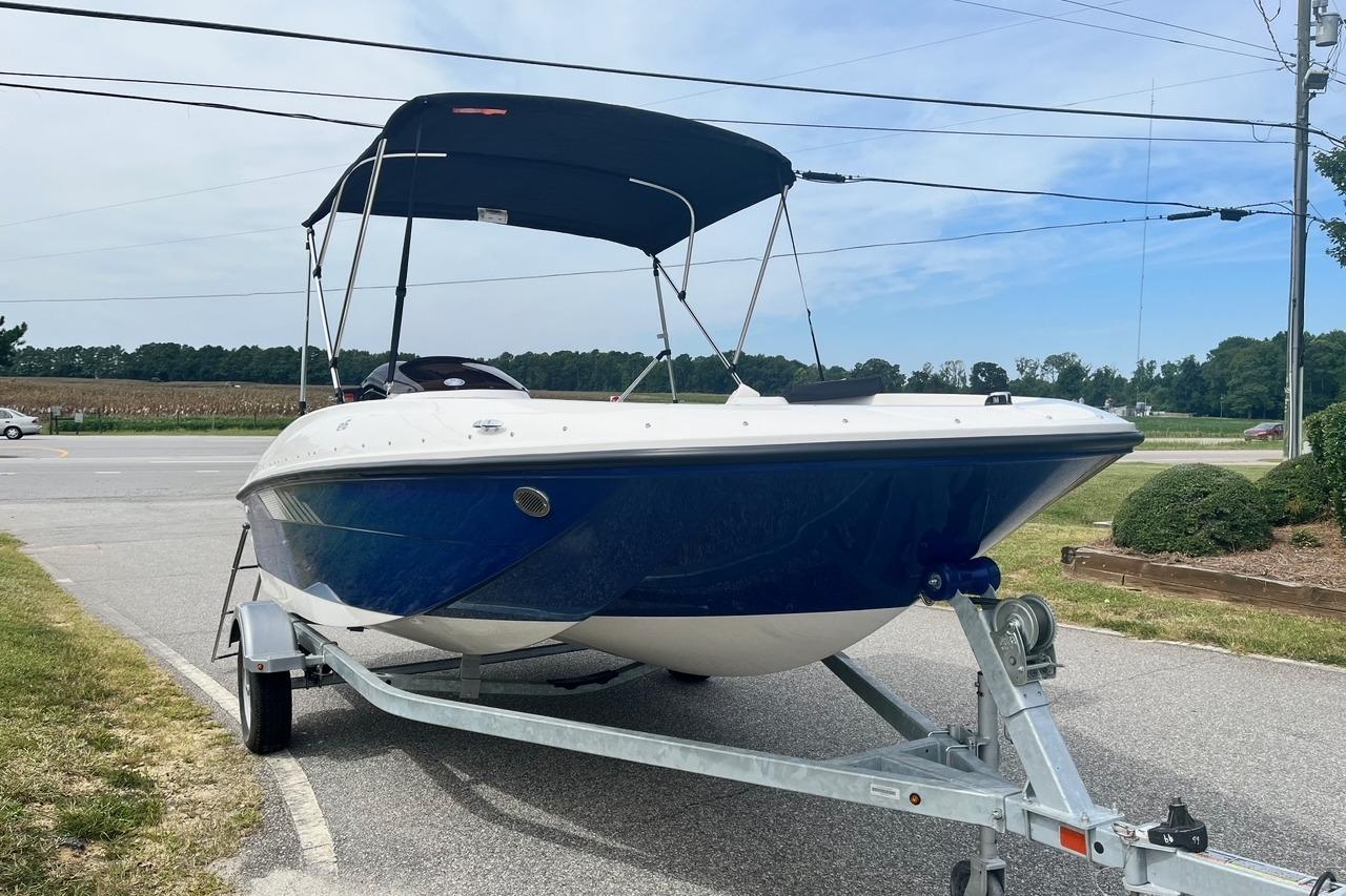 2026 Bayliner Element E16 boat on trailer with canopy, parked roadside.