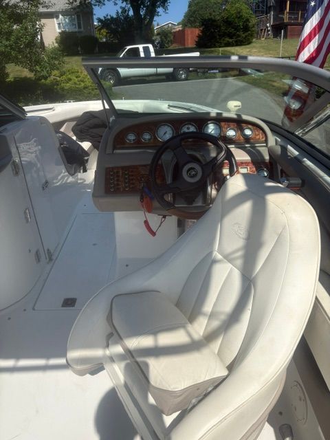 The image shows the cockpit of a 2003 Cobalt 240 boat with a white leather seat.