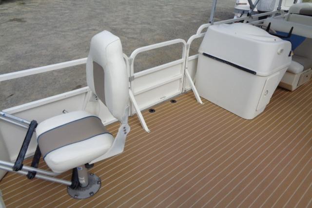 2008 Bentley Pontoons 200 CRUISE interior with seating and storage on a wooden deck.