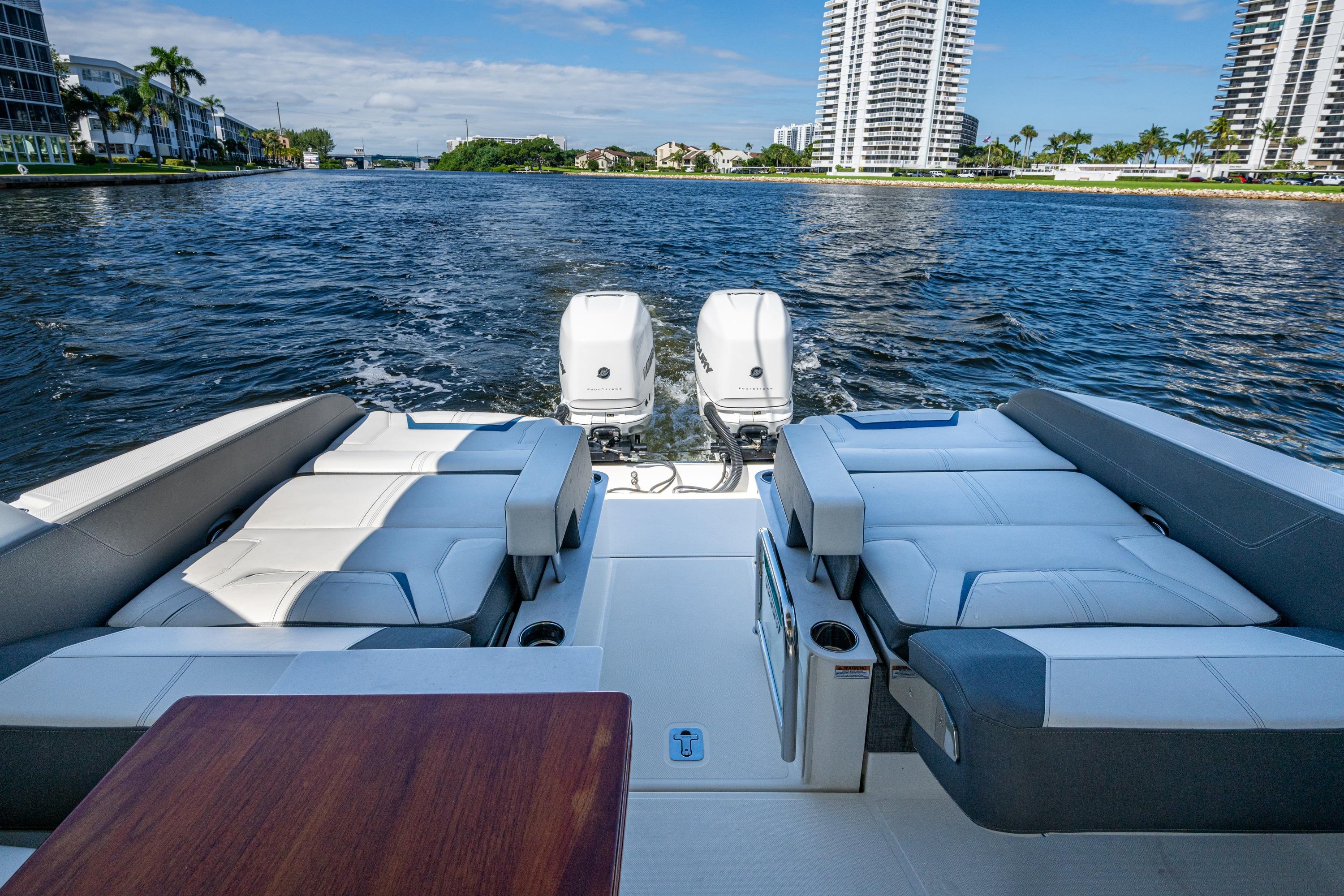 2021 Tiara Yachts 34 LX on water, featuring luxurious seating and twin outboard engines.