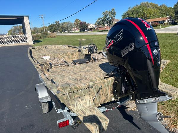 2025 Lowe Roughneck 2070 SC boat with camo design and powerful outboard motor.