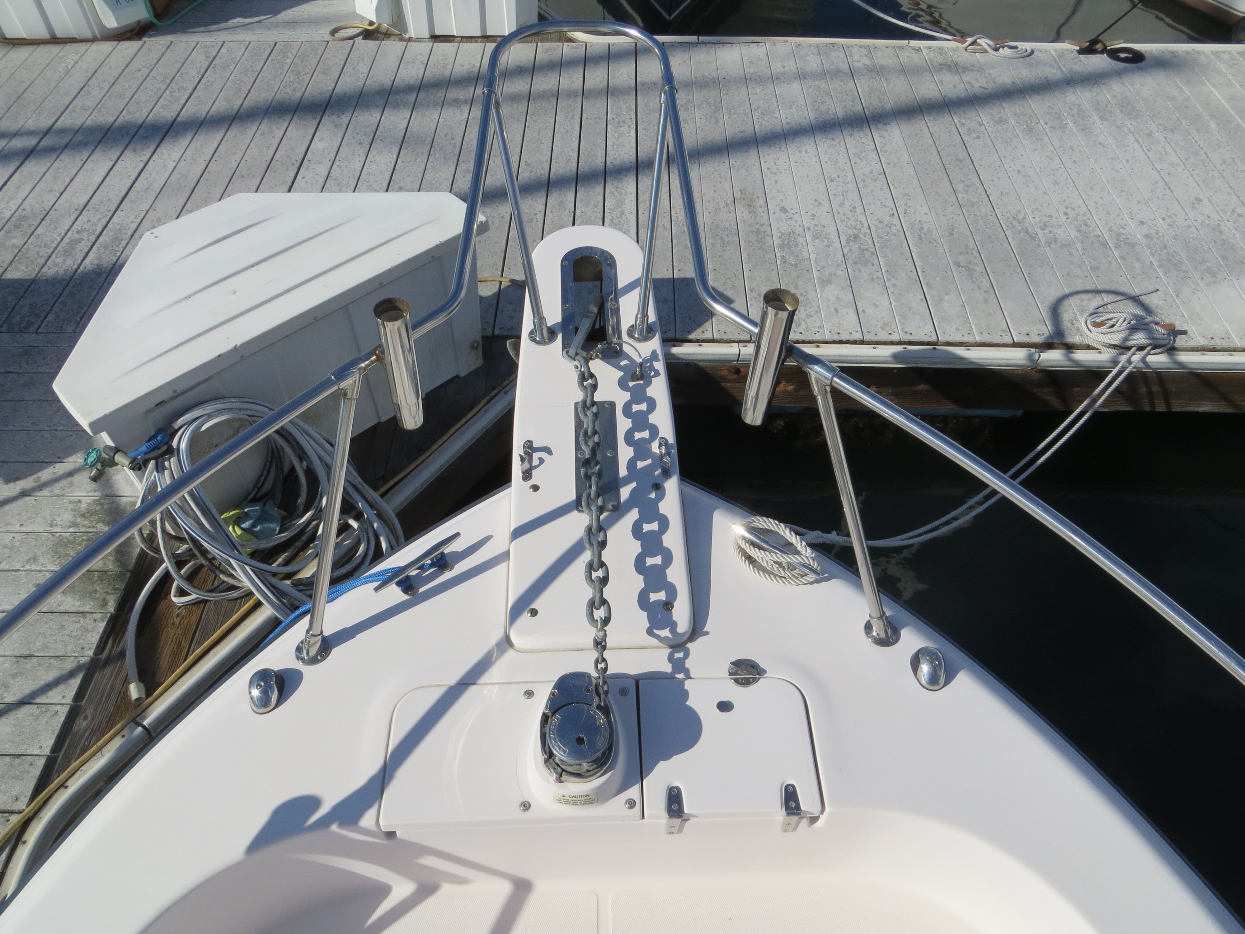 The bow of a 2007 Grady-White Sailfish 282 with anchor chain and cleats at the dock.