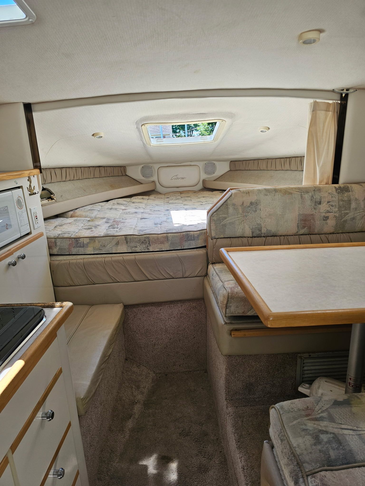 Interior of the 1998 Bayliner 2855 Ciera Sunbridge with sleeping area and seating nook.