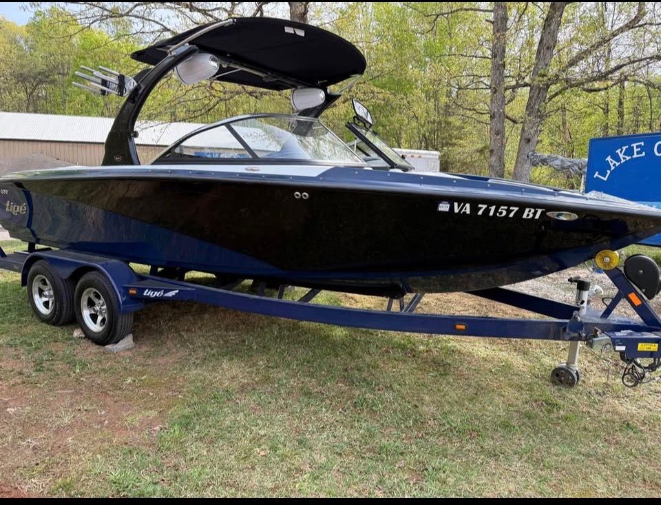 2010 Tigé Z1 boat parked on trailer outdoors.
