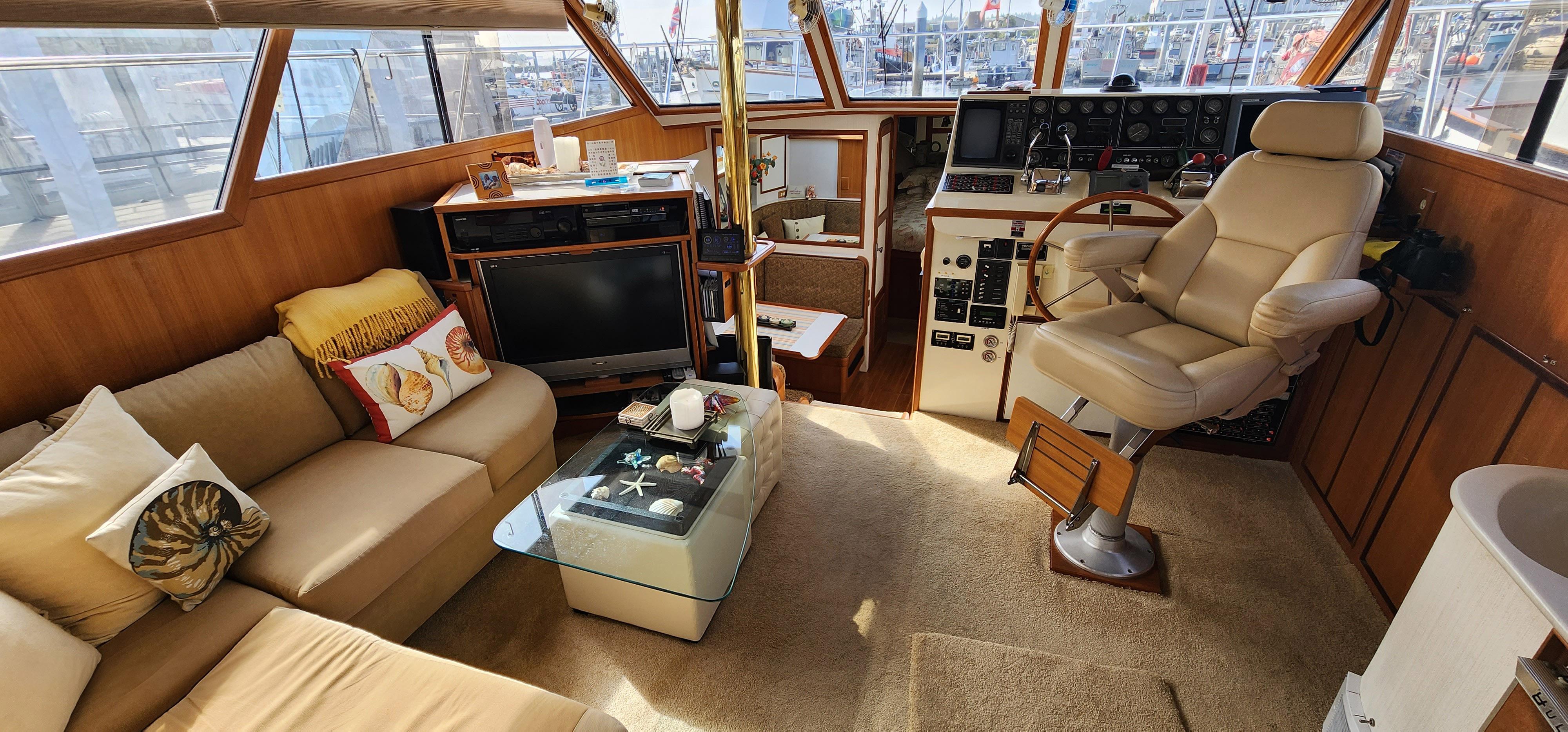 1988 Vantare 44 Aft Cabin interior with helm, seating, and entertainment area.