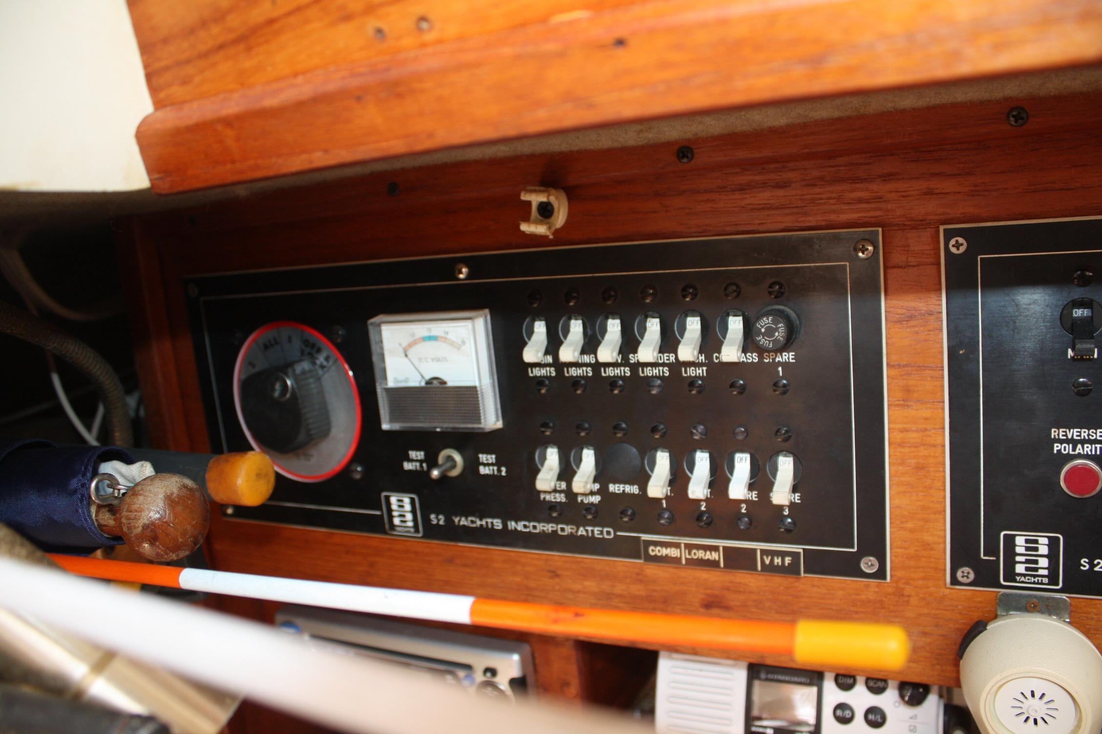 Electrical control panel of a 1981 S2 9.2A yacht with switches and gauges.
