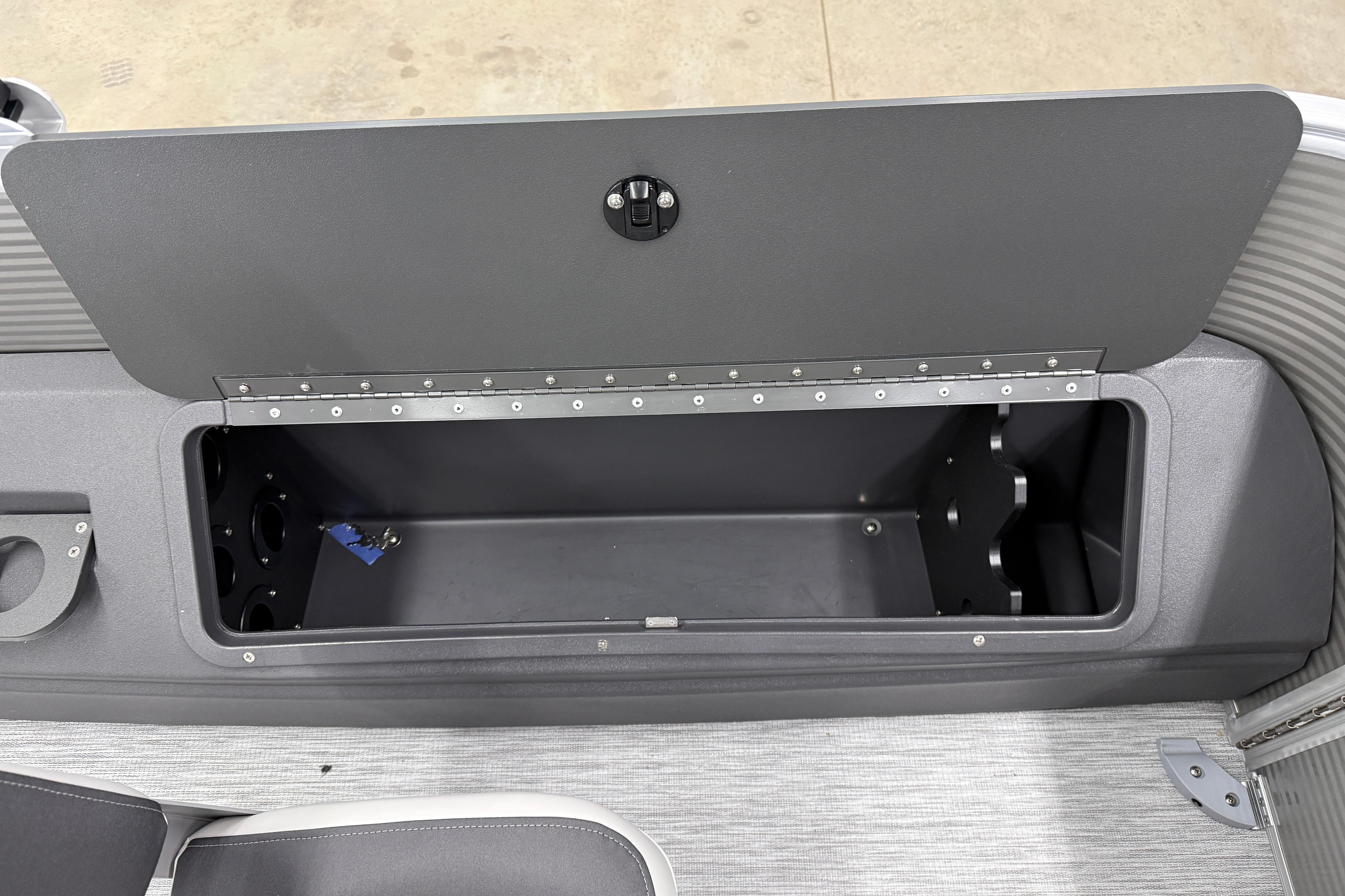 Open storage compartment on 2026 Bennington 20 SF boat, featuring sleek design and ample space.