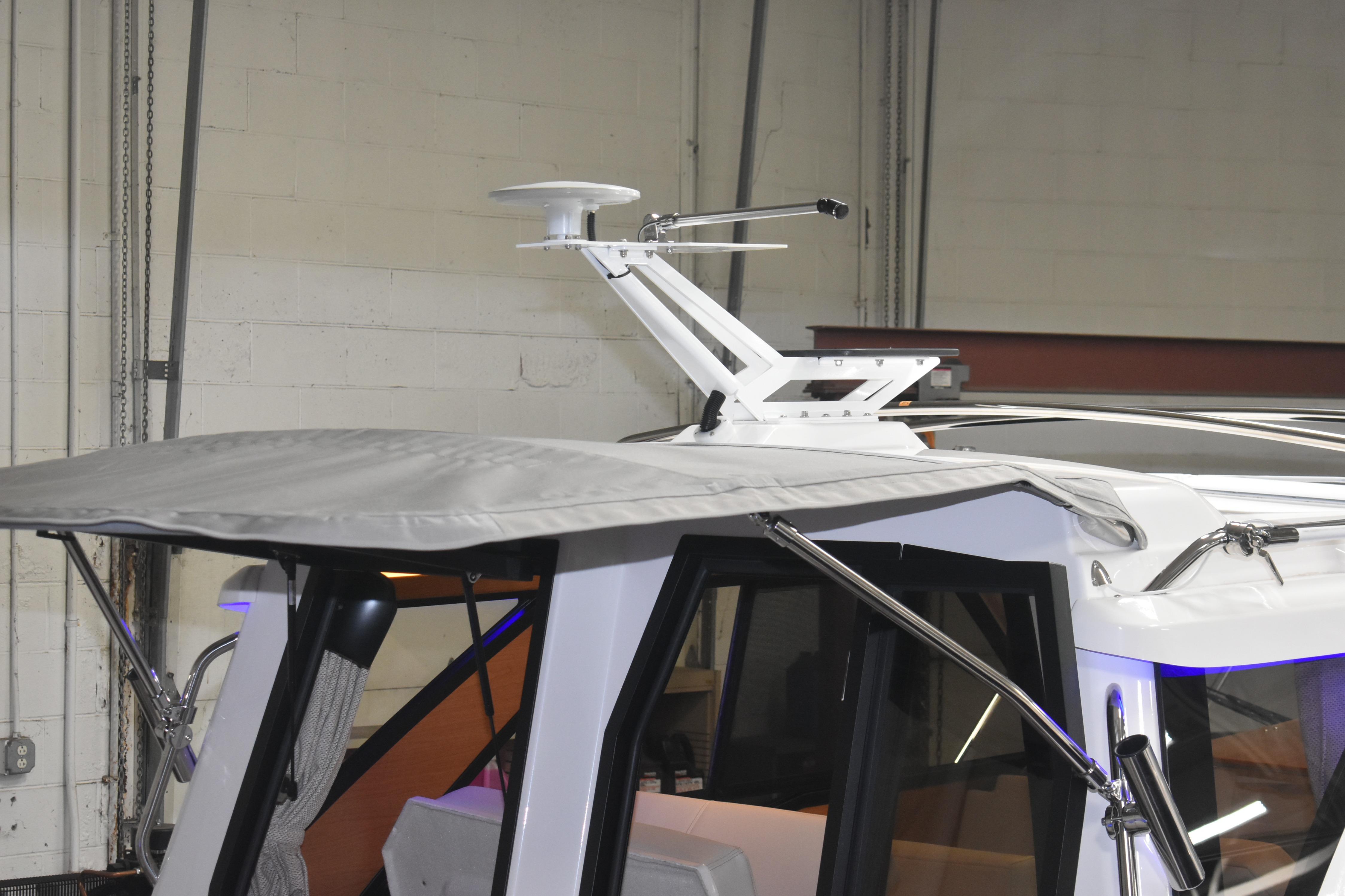 2026 Cutwater C-248 Coupe boat roof with radar and canopy in a garage setting.