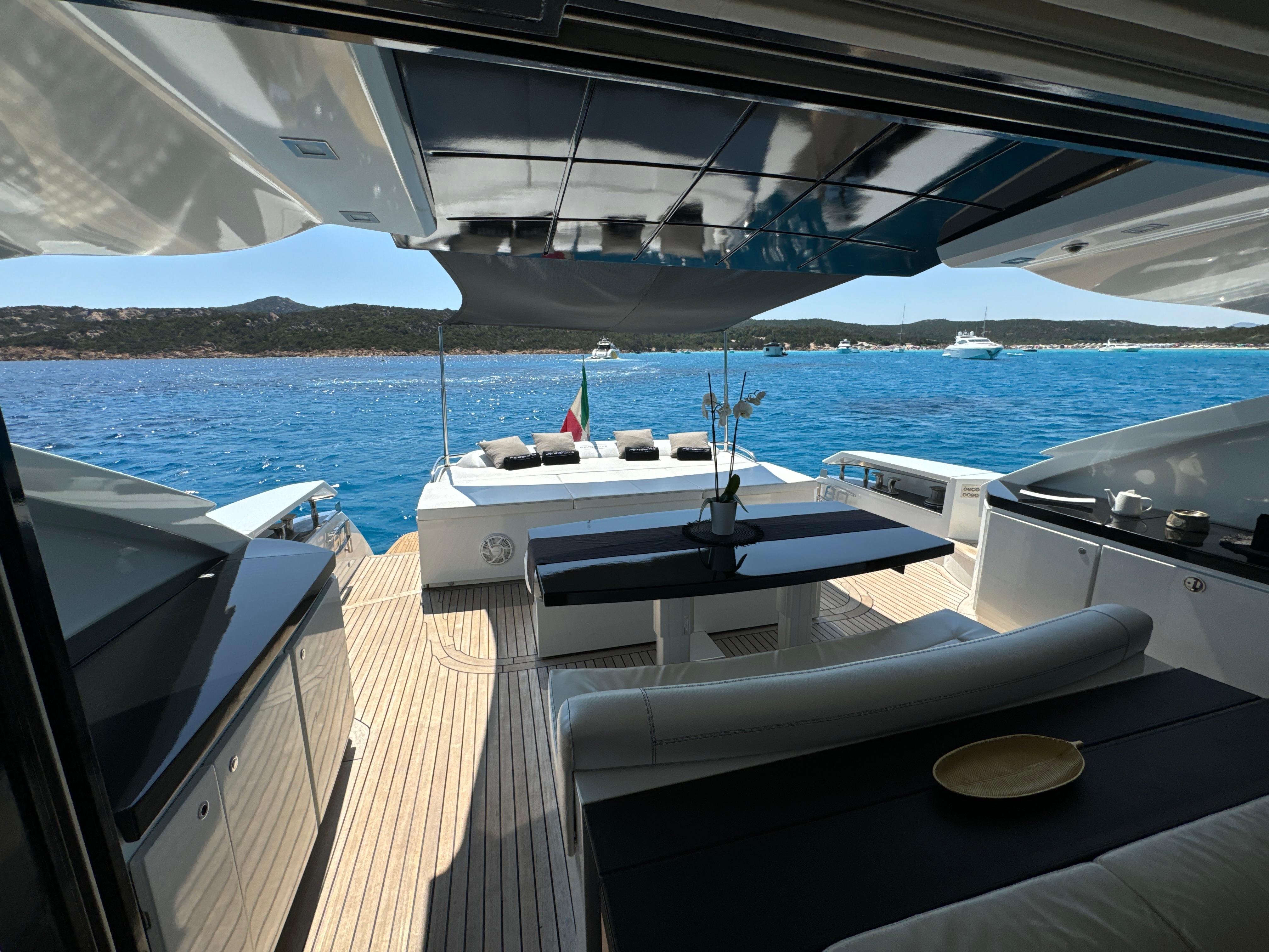 Luxurious 2008 Pershing 80 yacht deck with elegant seating and stunning ocean view.
